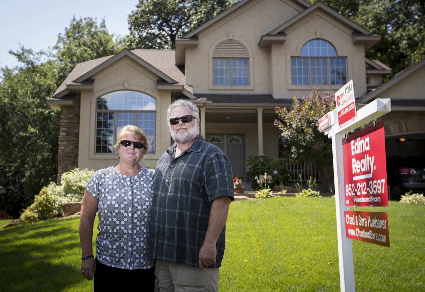 Mary and Mitchell Roach posed for a photograph in front of their home on Tuesday, August 2, 2016, in Savage, Minn. The Savage home, 13960 Woodridge Path, has been on the market since April and they have yet to have an offer. ] RENEE JONES SCHNEIDER &#x2022; renee.jones@startribune.com After putting their 4,000-plus square-foot house in Savage on the market in April, Mary and Mitchell Roach have done three price reductions and still no offers. Their neighbors were in the same boat and were so fru