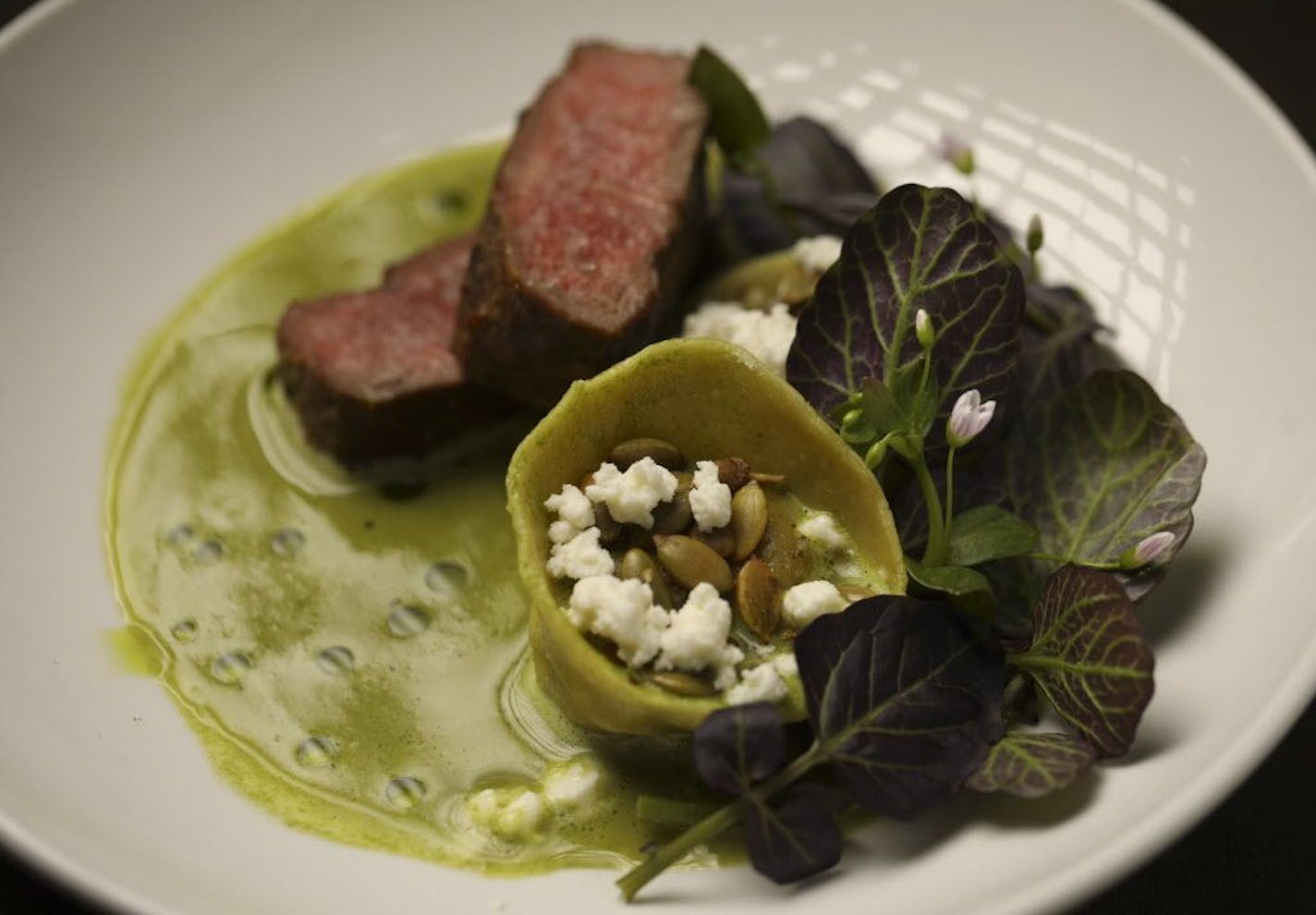 Roasted lamb and lamb tortelli, with green brodo, feta, and watercress, as prepared at Corner Table.