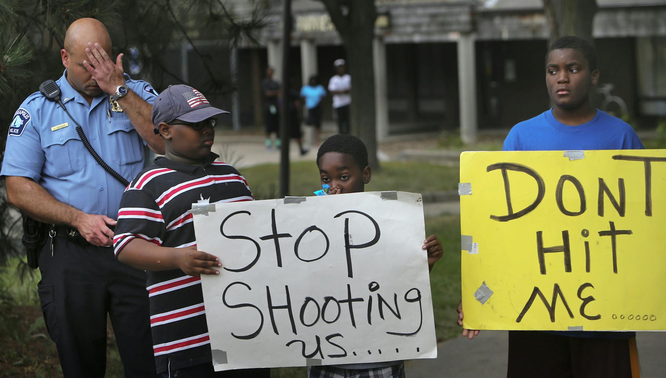 Minneapolis police Lt. Chris Granger listened in during the vigil at 29th and Lyndale Ave. N. Wednesday, Aug. 21, 2013, in Minneapolis, MN. Granger went on to address those gathered, asking for the public's help in bringing the shooter to justice.](DAVID JOLES/STARTRIBUNE) djoles@startribune.com The gunfire didn't kill anybody this time, but the shooting of a 14-month-old baby and a pregnant woman Tuesday brought fresh attention and outrage to the seemingly commonplace shots fired on north Minne
