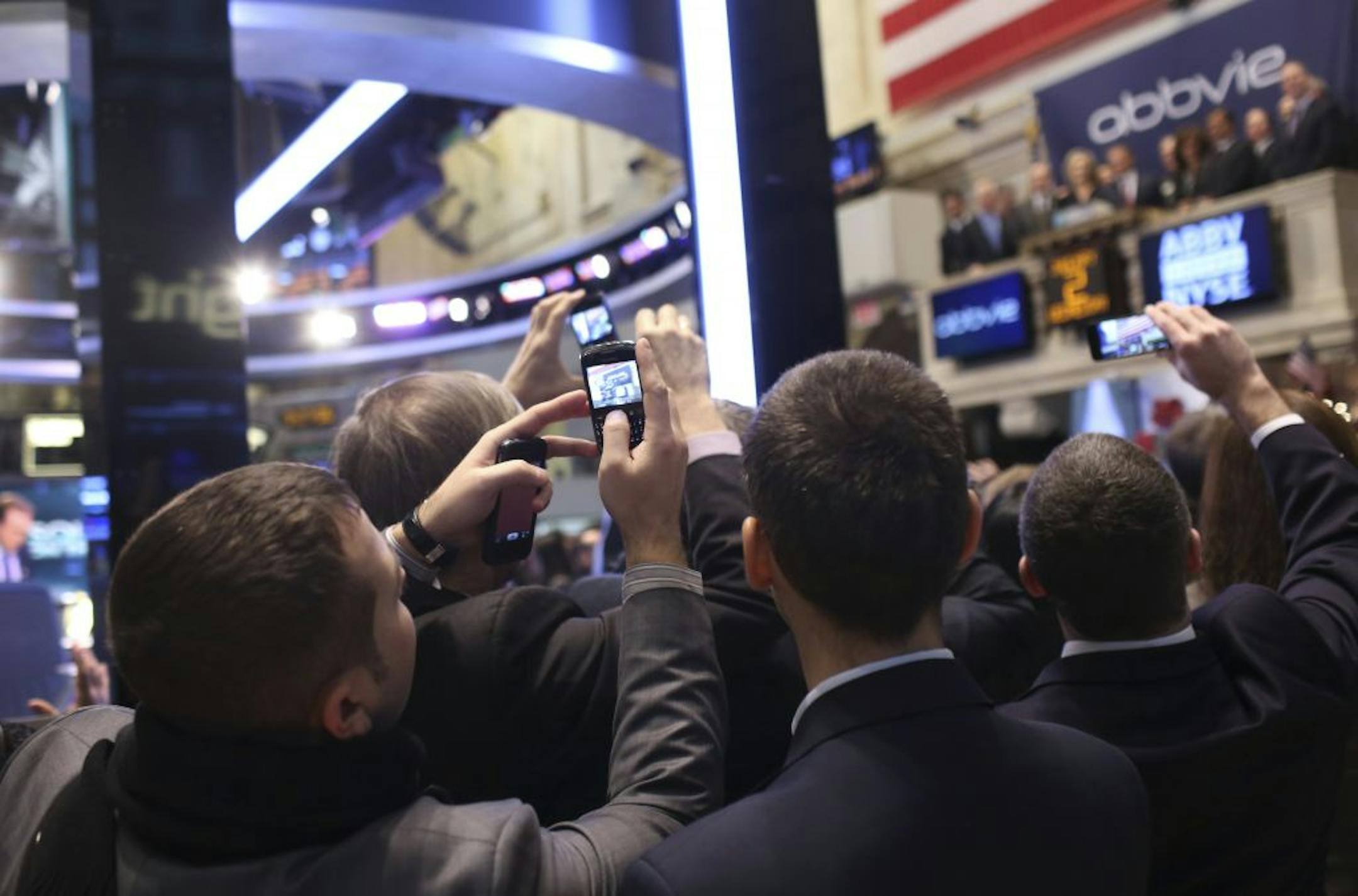 Visitors took photos as the opening bell rang at the New York Stock Exchange on Wednesday. Global stocks kicked off the 2013 trading year with a strong showing.