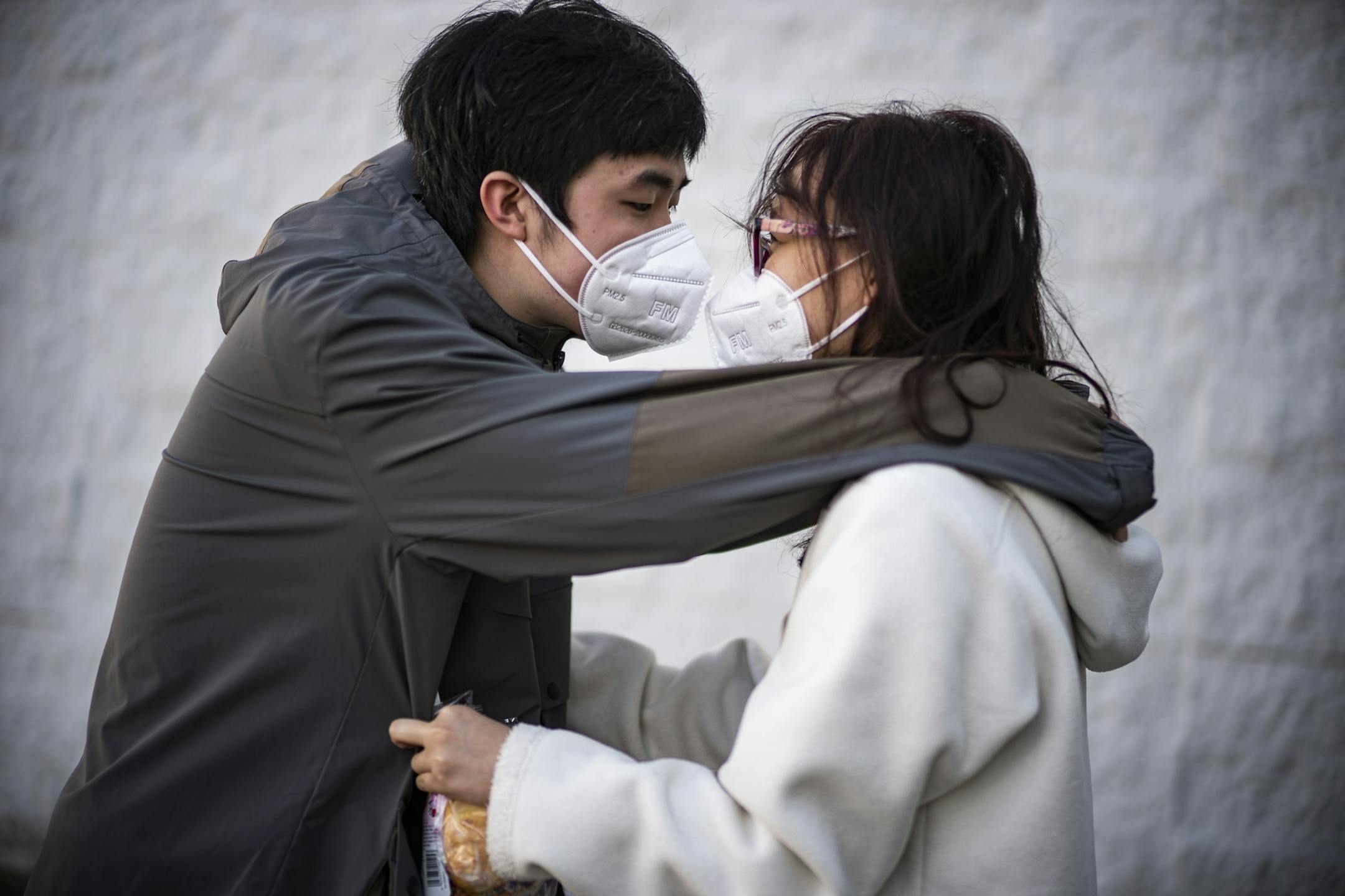 NYU student Chris Cao and girlfriend Christy Wang who goes to the U of M nuzzle after shopping at United Noodle. Cao left New York City to live with his girlfriend because of the intensity of the pandemic there.