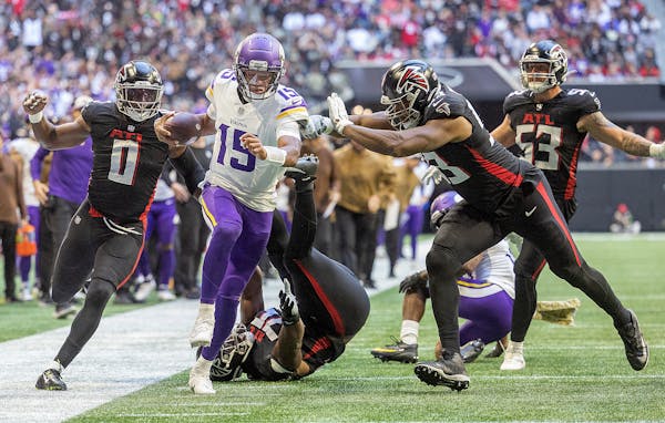 Vikings quarterback Joshua Dobbs (15) breaks loose from the defense and scores a touchdown in the third quarter.