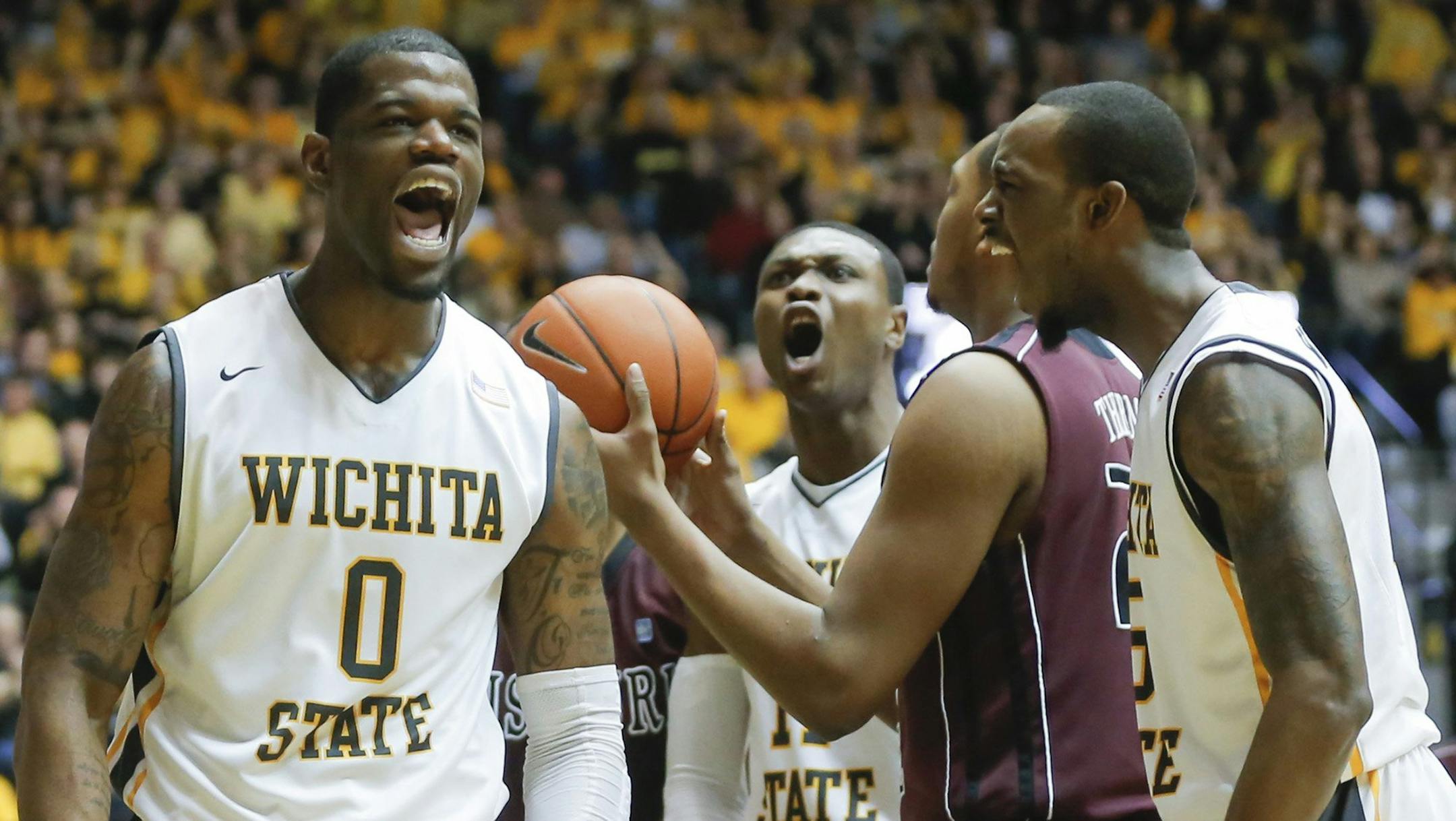 Wichita State's Chadrack Lufile (0) celebrates, after being fouled by Missouri State's Devon Thomas, middle, along with teammates Cleanthony Early and Nick Wiggins, right, during the first half at Koch Arena in Wichita, Kan., on Saturday, March 1, 2014. The host Shockers won, 68-45, to complete a 31-0 record in the regular season. (Travis Heying/Wichita Eagle/MCT) ORG XMIT: 1149830