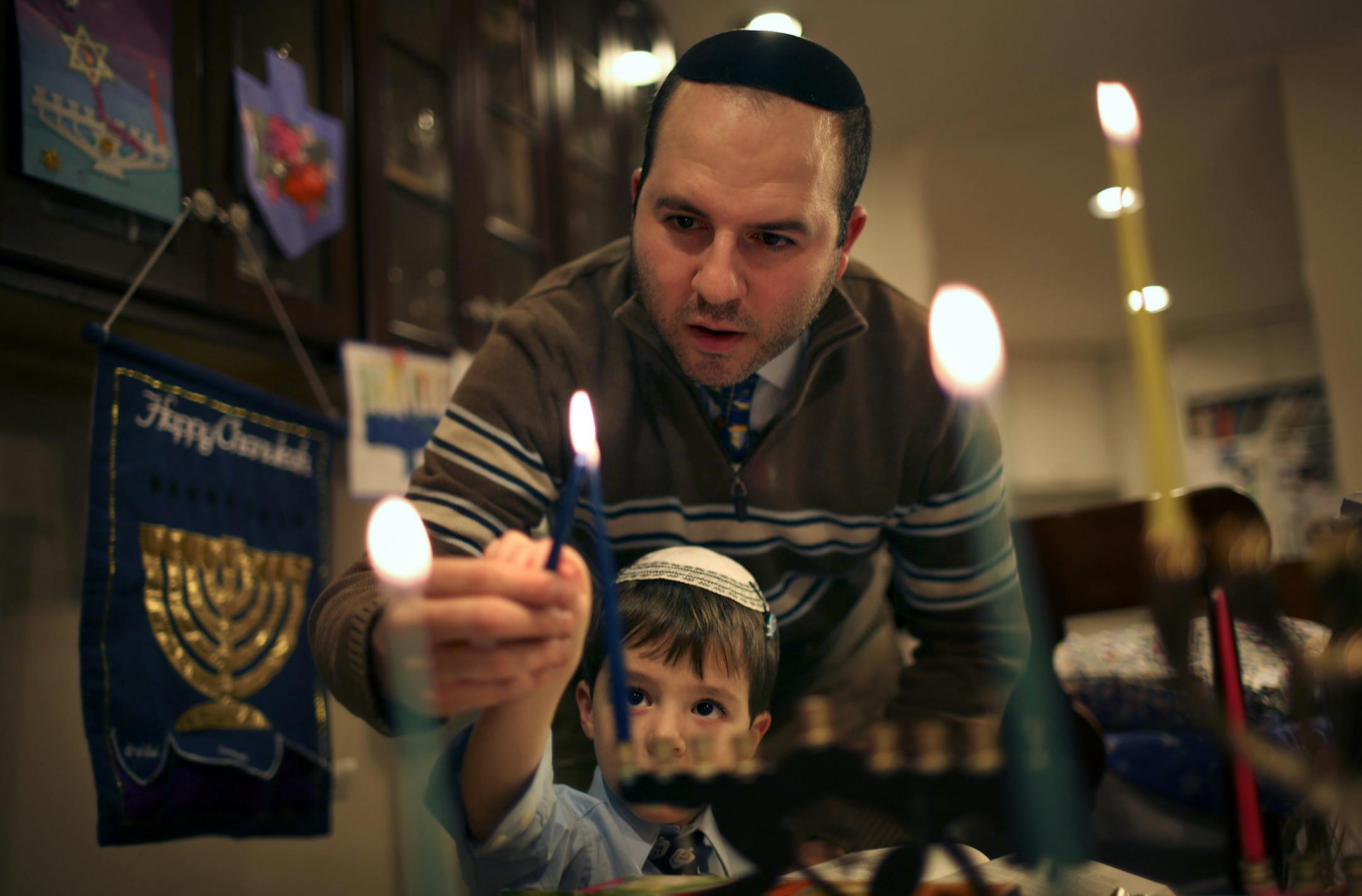 Rabbi Avi Olitzky, his wife, Sarah, and their three children lit the first candle of Hanukkah Wednesday evening in their St. Louis Park home. Hanukkah is unusually early this year. Through a quirk of the Jewish and Gregorian calendars, the first night of Hanukkah and Thanksgiving share the same day for the first time since 1888. They won't coincide again until 81,056. Or 2070, depending on a which source you want to believe. Rabbi Avi Olitzky helped his son, Akiva, 4, light a candle on his menor