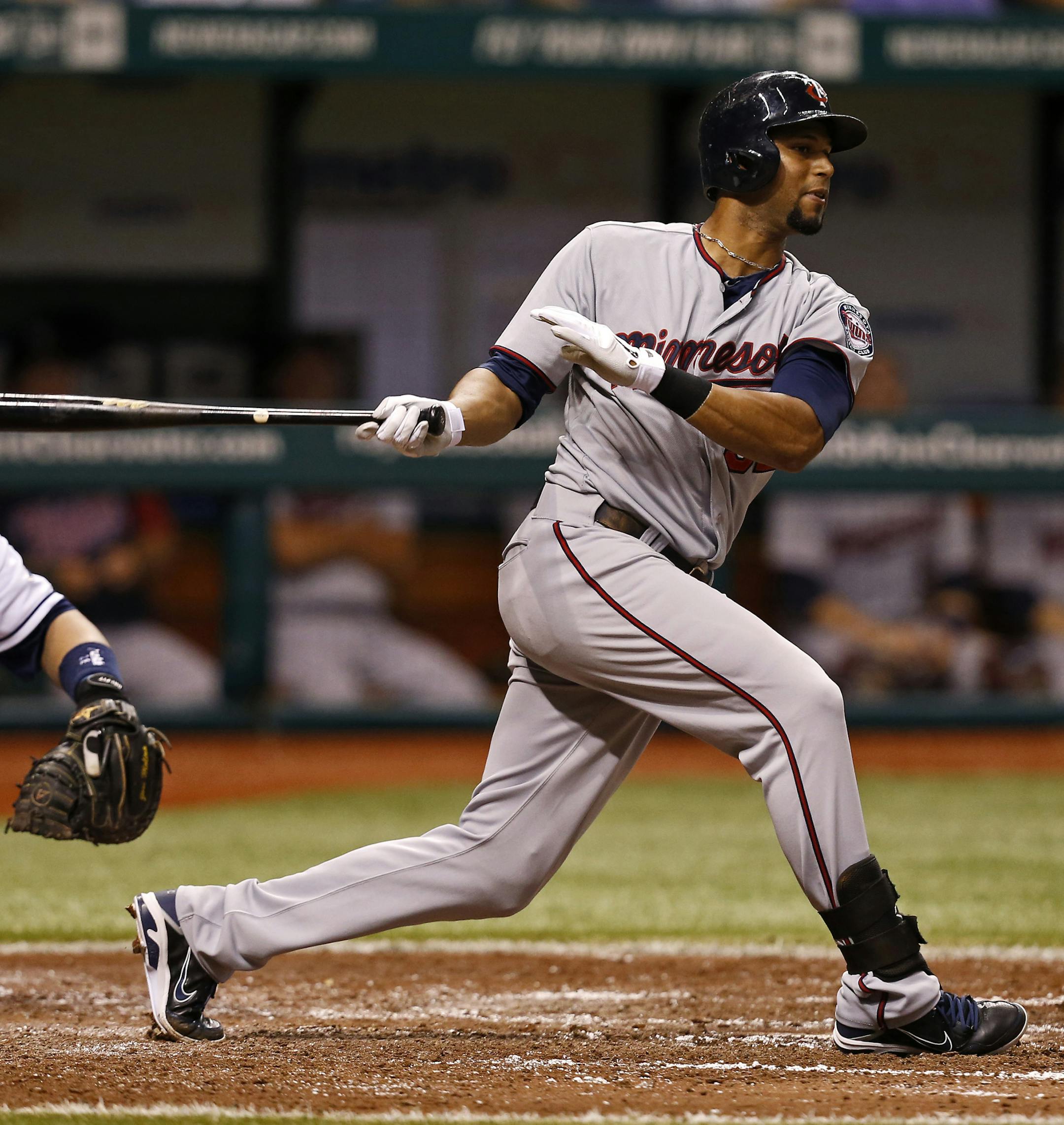 Minnesota Twins' Aaron Hicks follows through on a double in front of Tampa Bay Rays catcher Jose Molina during the fifth inning of a baseball game Wednesday, July 10, 2013, in St. Petersburg, Fla. (AP Photo/Mike Carlson)