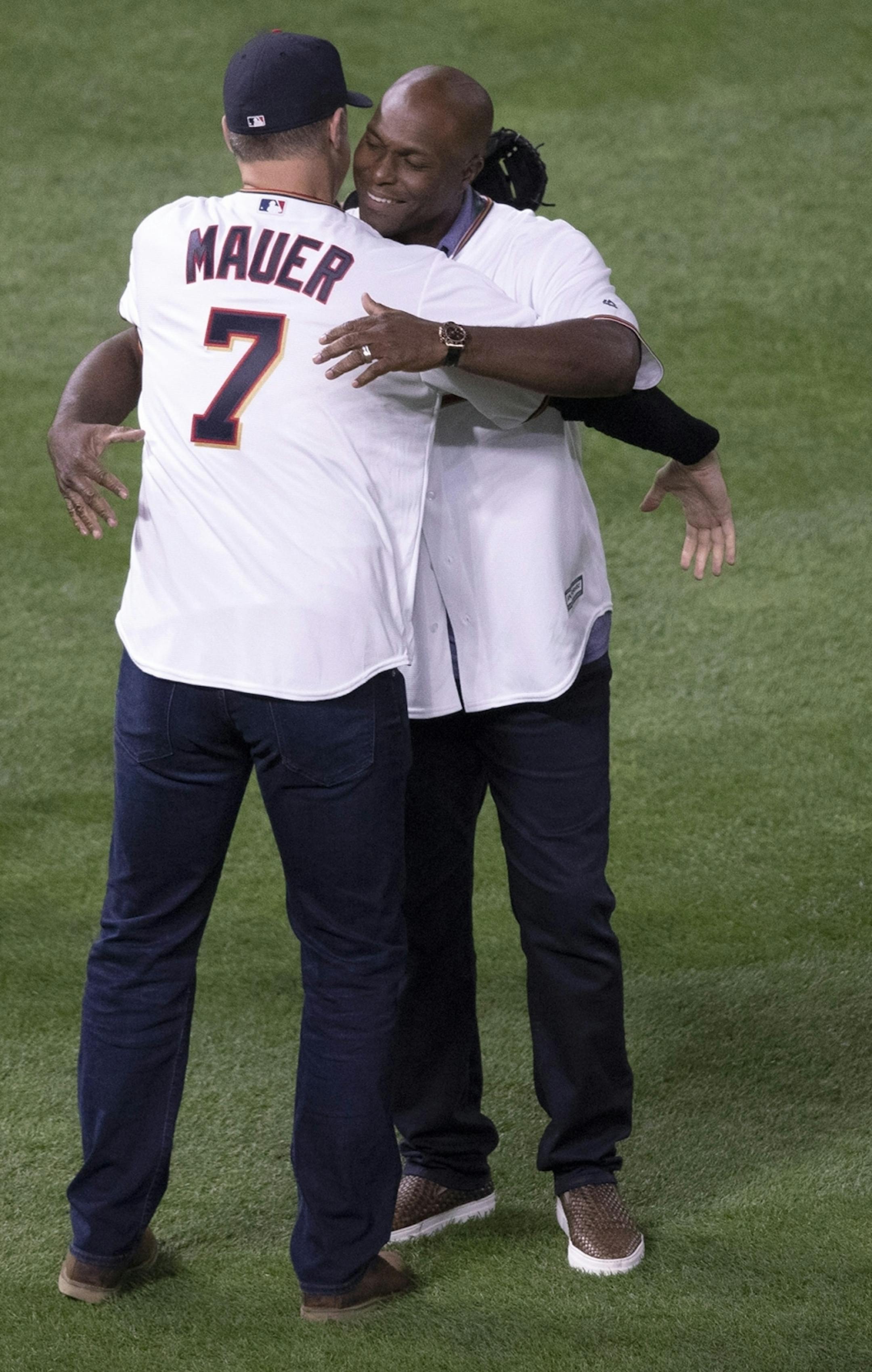 Former Twins Joe Mauer left and Torii Hunter hugged each other after Hunter threw out the fist pitch during the third game of the ALDS playoffs at Target Field.