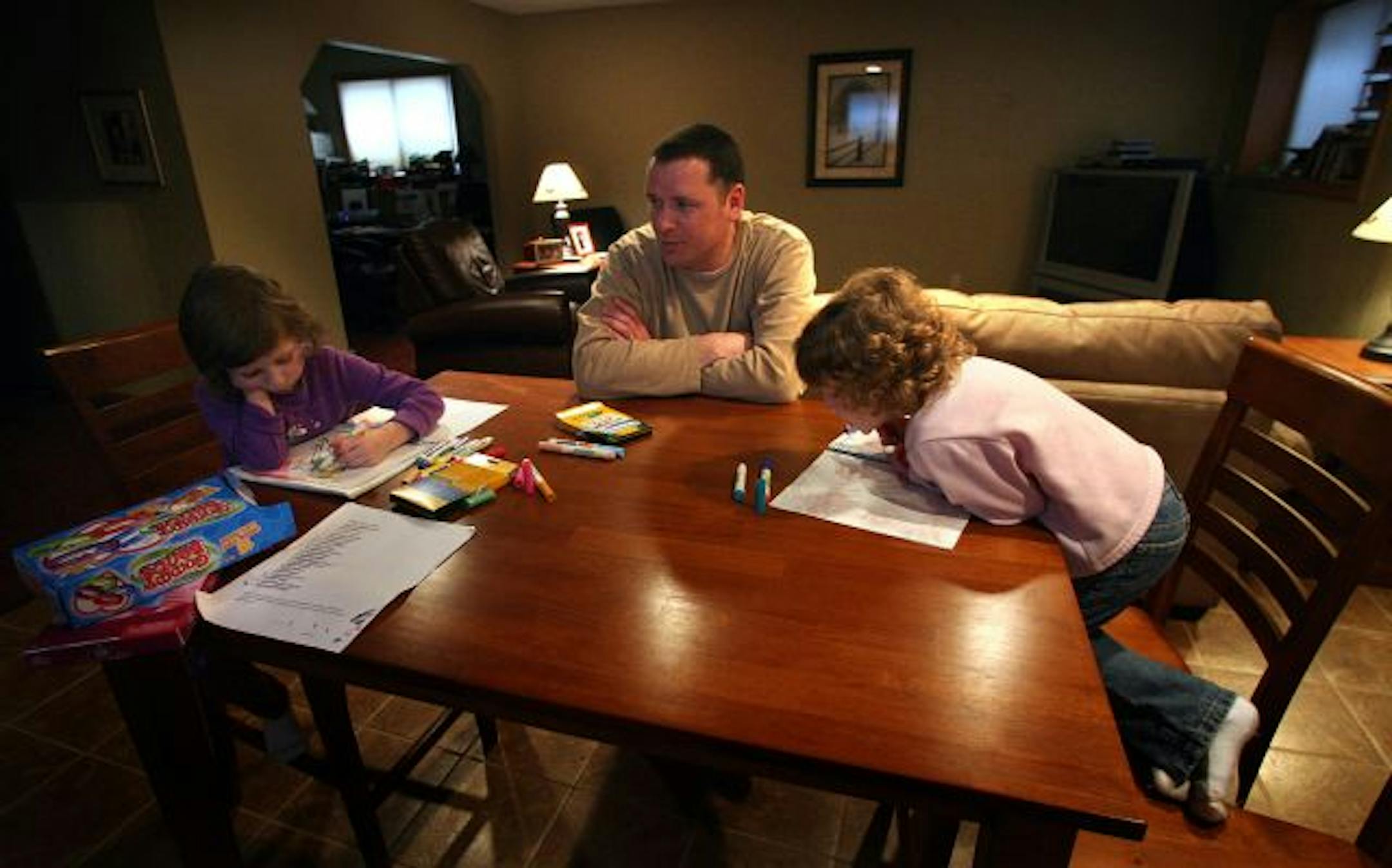 Tom Bystrom made a decent living as a mason until construction work dried up. Soon child care bills were higher than his income, so he and his wife pulled their daughters, Lila, left, and Madie, out of day care.