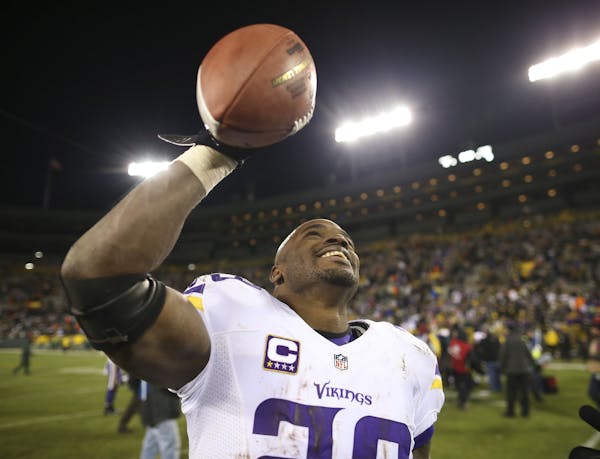 Adrian Peterson held the game ball as he walked off the field after the Vikings defeated Green Bay in January 2016 to win the NFC North. Peterson will