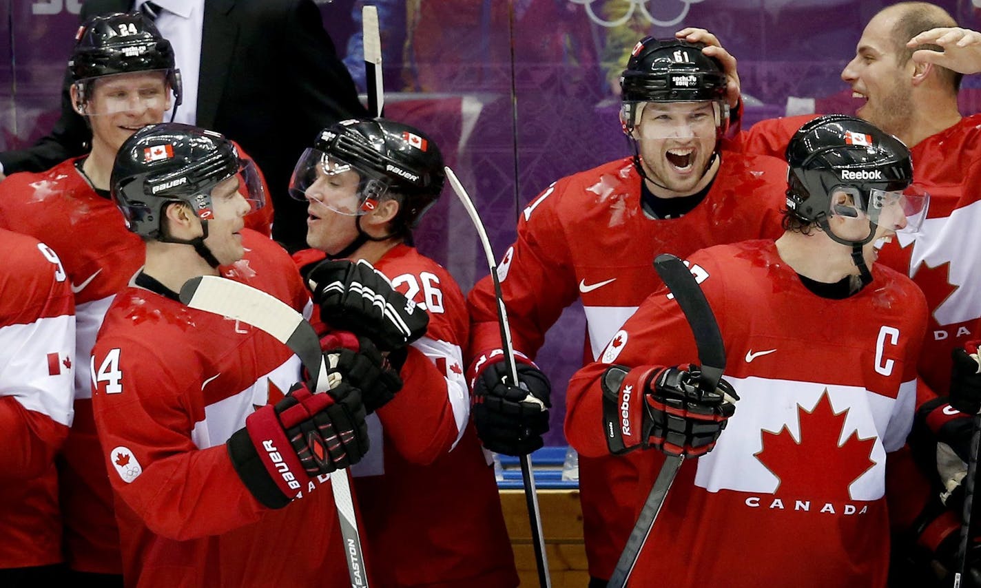 Players on the Canada bench celebrated in the final seconds of the game in men's hockey at the Winter Olympics in Sochi, Russia, on Sunday. Canada won the gold medal after defeating Sweden 3-0.