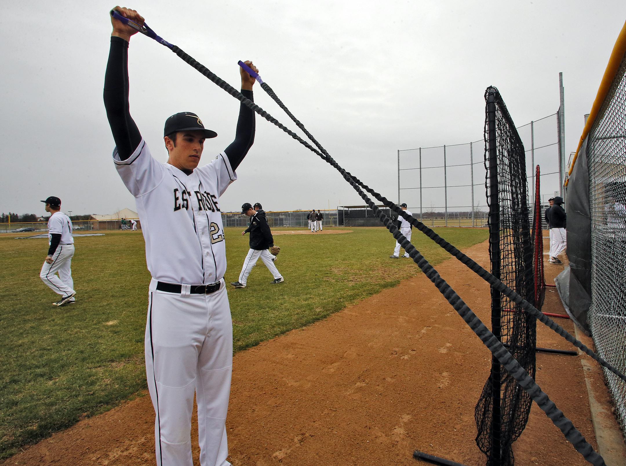 East Ridge pitcher Cal Kellner used a rubber band device to warm up before a recent start. He missed his freshman year because of a partly torn elbow ligament.