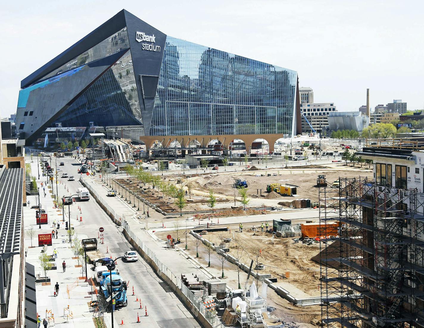 Newly planted trees line the park which adjoins the U.S. Bank Stadium the new stadium for the home to the Minnesota Vikings NFL football team, Wednesday, May 5, 2016, in Minneapolis, as work continues toward the completion of the $1.2 billion stadium. (AP Photo/Jim Mone)