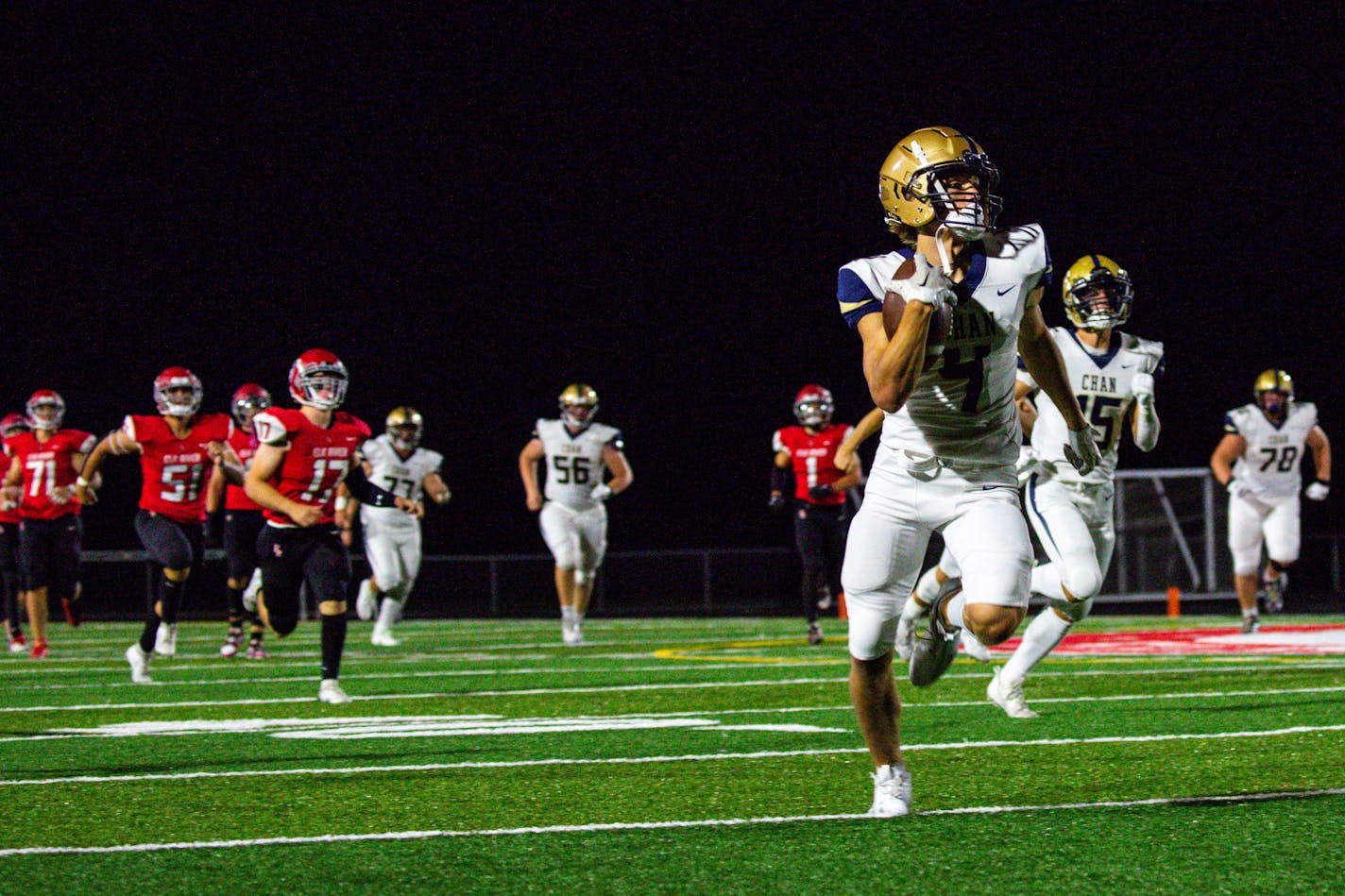 Chanhassen wide receiver Daxton Bush (4) breaks away from Elk River defense for a first down in the second half of the opening night game between Elk River High School and Chanhassen High School Thursday, Aug. 31, 2023 at Elk River High School.