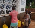 Villagers in the first "Asili" social-enterprise zone in the eastern part of the Democratic Republic of Congo buy water from workers at a community-ow