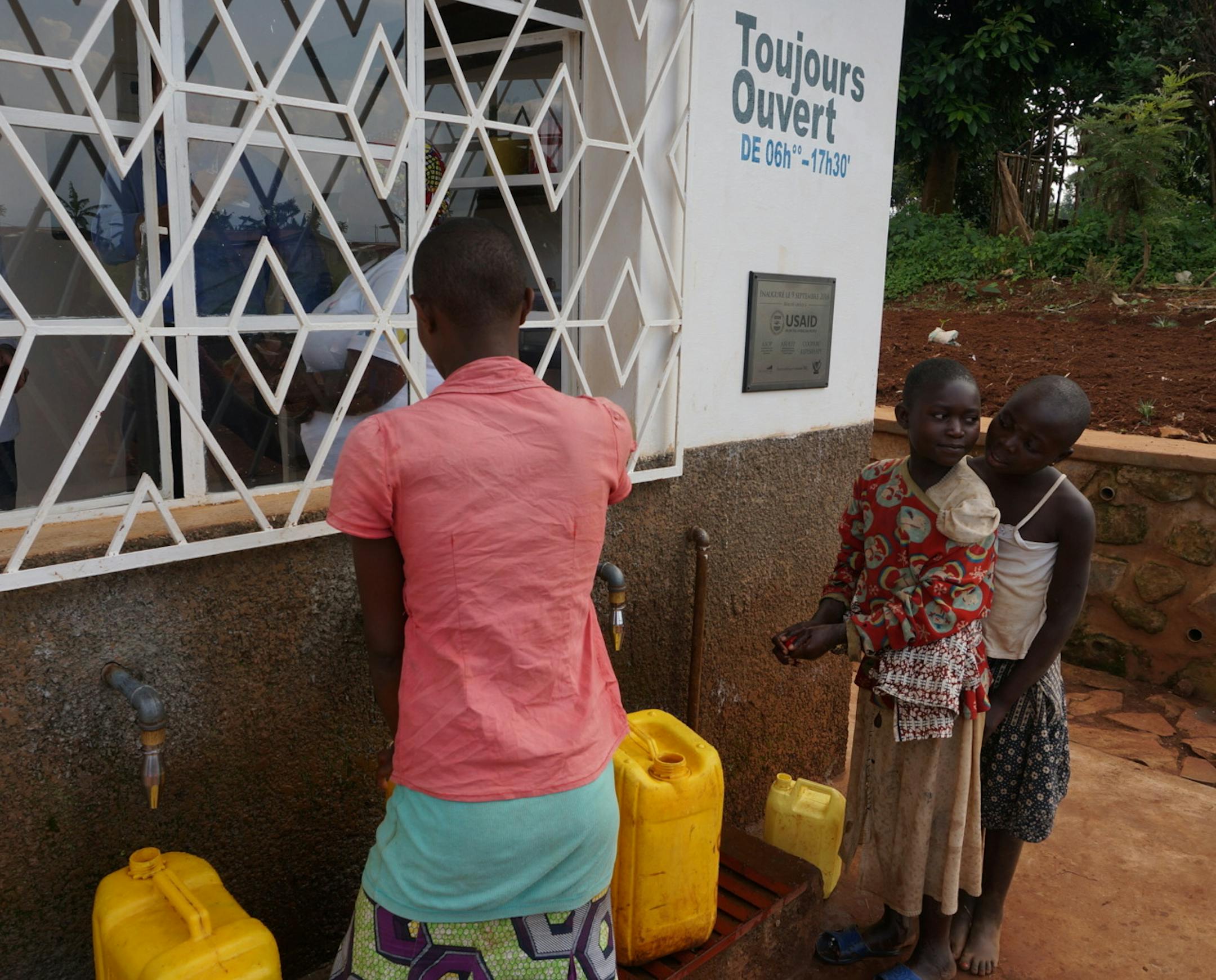Villagers in the first "Asili" social-enterprise zone in the eastern part of the Democratic Republic of Congo buy water from workers at a community-owned clean-water station, part of several water, healthcare and small-farm enterprises designed to boost incomes of hundreds of involved families in what has been a war-torn, impovershed area. The sponsors in the first community-owned enterprise district include Minneapolis businessman and philanthopist Ward Brehm, Minneapolis-based American Refugee