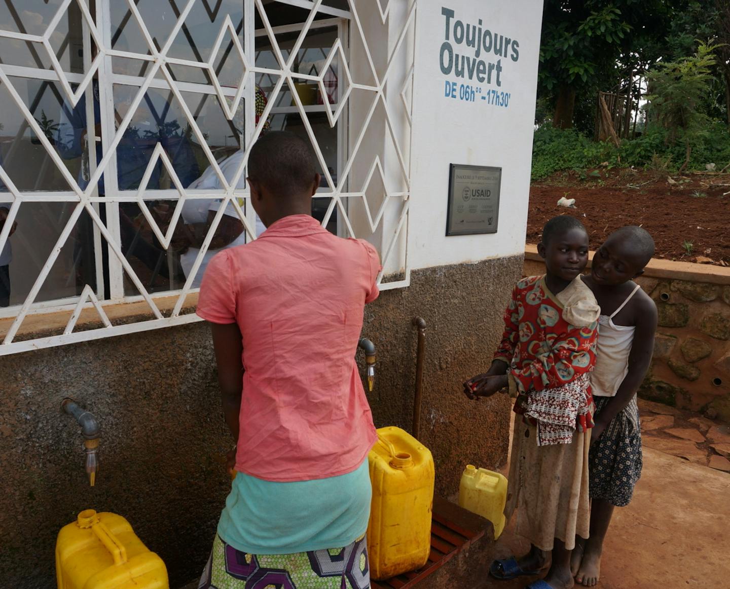 Villagers in the first "Asili" social-enterprise zone in the eastern part of the Democratic Republic of Congo buy water from workers at a community-owned clean-water station, part of several water, healthcare and small-farm enterprises designed to boost incomes of hundreds of involved families in what has been a war-torn, impovershed area. The sponsors in the first community-owned enterprise district include Minneapolis businessman and philanthopist Ward Brehm, Minneapolis-based American Refugee