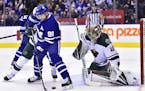 Toronto Maple Leafs center John Tavares (91) tries to locate the puck in front of Minnesota Wild goaltender Devan Dubnyk (40) during the second period