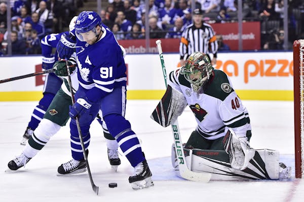 Toronto Maple Leafs center John Tavares (91) tries to locate the puck in front of Minnesota Wild goaltender Devan Dubnyk (40) during the second period