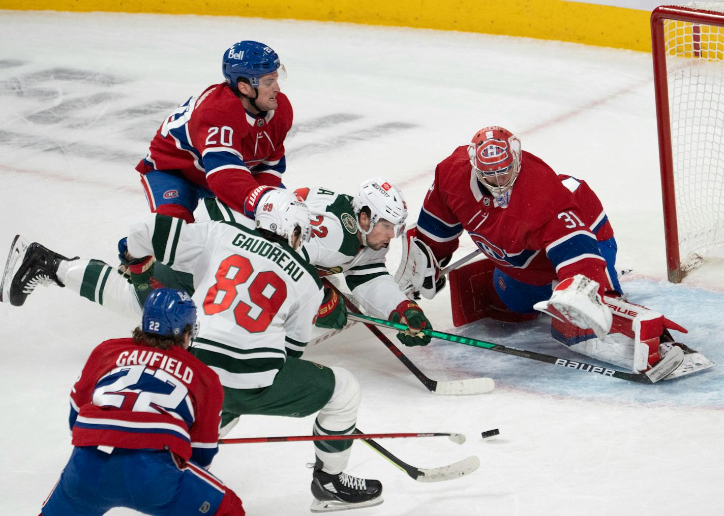 Canadiens goaltender Carey Price stopped the Wild's Kevin Fiala (22) while Montreal's Chris Wideman (20) and Cole Caufield and the Wild's Frederick Gaudreau (89) closed in on the rebound during the first period Tuesday.