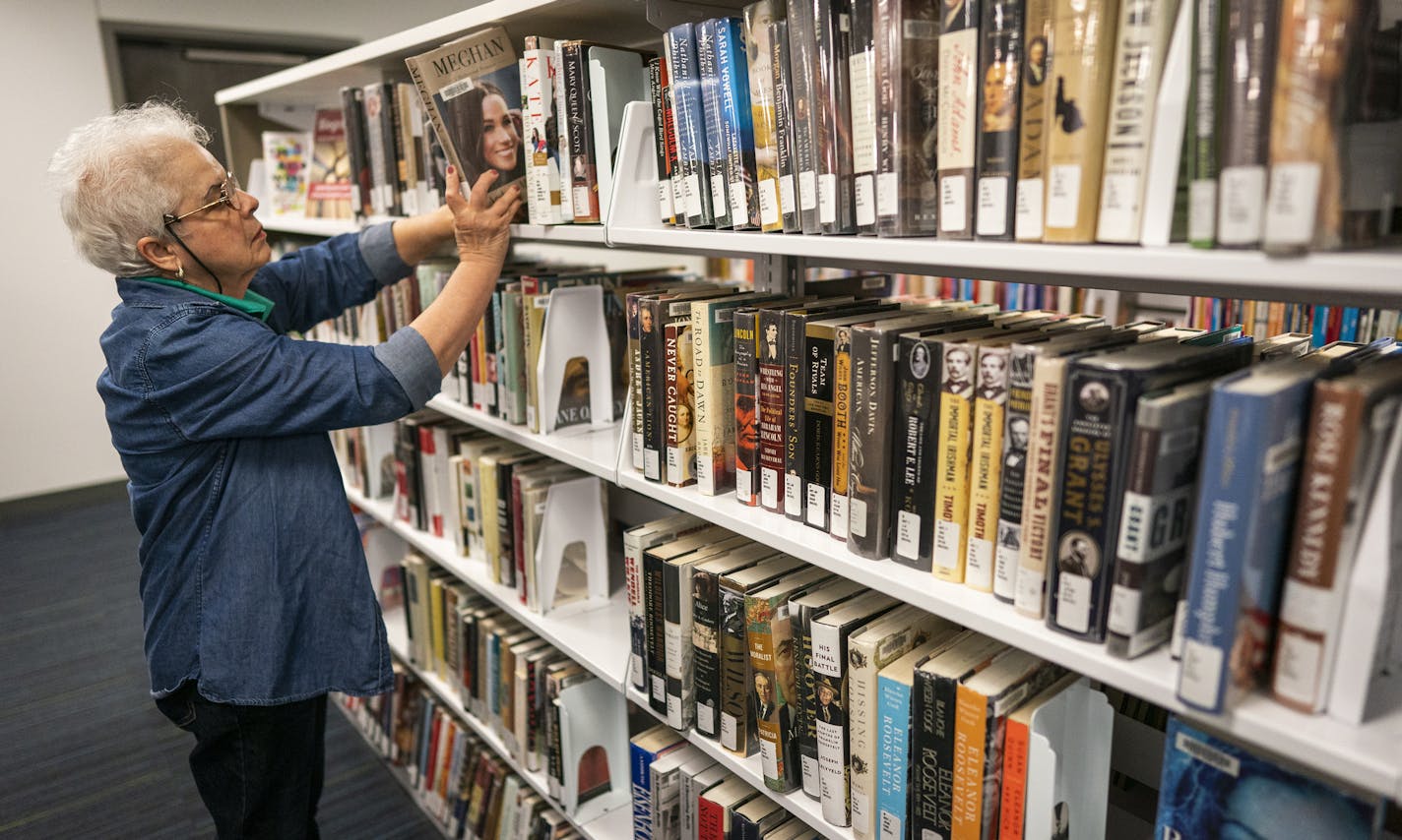 Concepcion Gonzalez shelved library books at the Highland Park branch on Tuesday, Sept. 9.