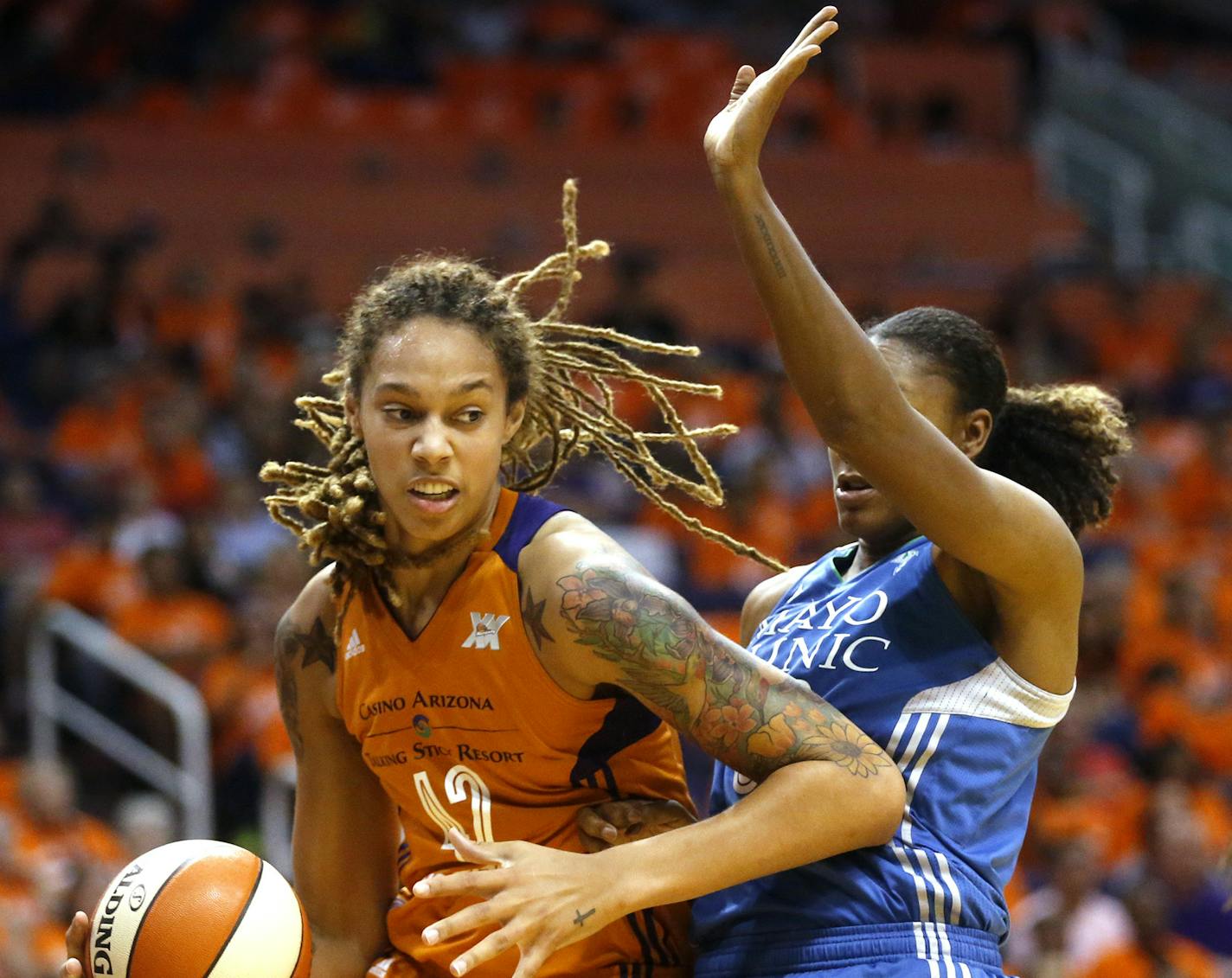 Minnesota Lynx forward Rebekkah Brunson, center, guards Phoenix Mercury center Brittany Griner during game 3 of the WNBA basketball semifinals in Scottsdale, Ariz., Sunday, Oct. 2, 2016. (Cheryl Evans/The Arizona Republic via AP) MARICOPA COUNTY OUT, NO SALES