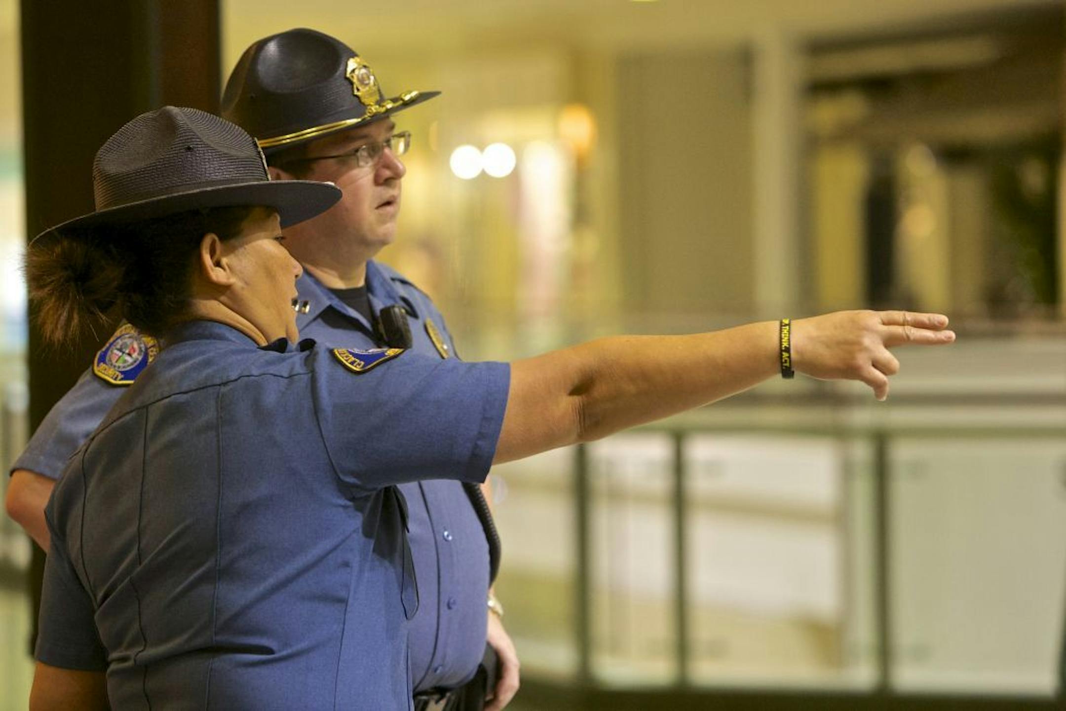 Security guards looks over the food court at the Clackamas Town Center mall as it opens, on Friday, Dec 14, 2012 in Portland, Ore., three days after a gunman killed two people and wounded a third amid a holiday shopping crowd estimated at 10,000.