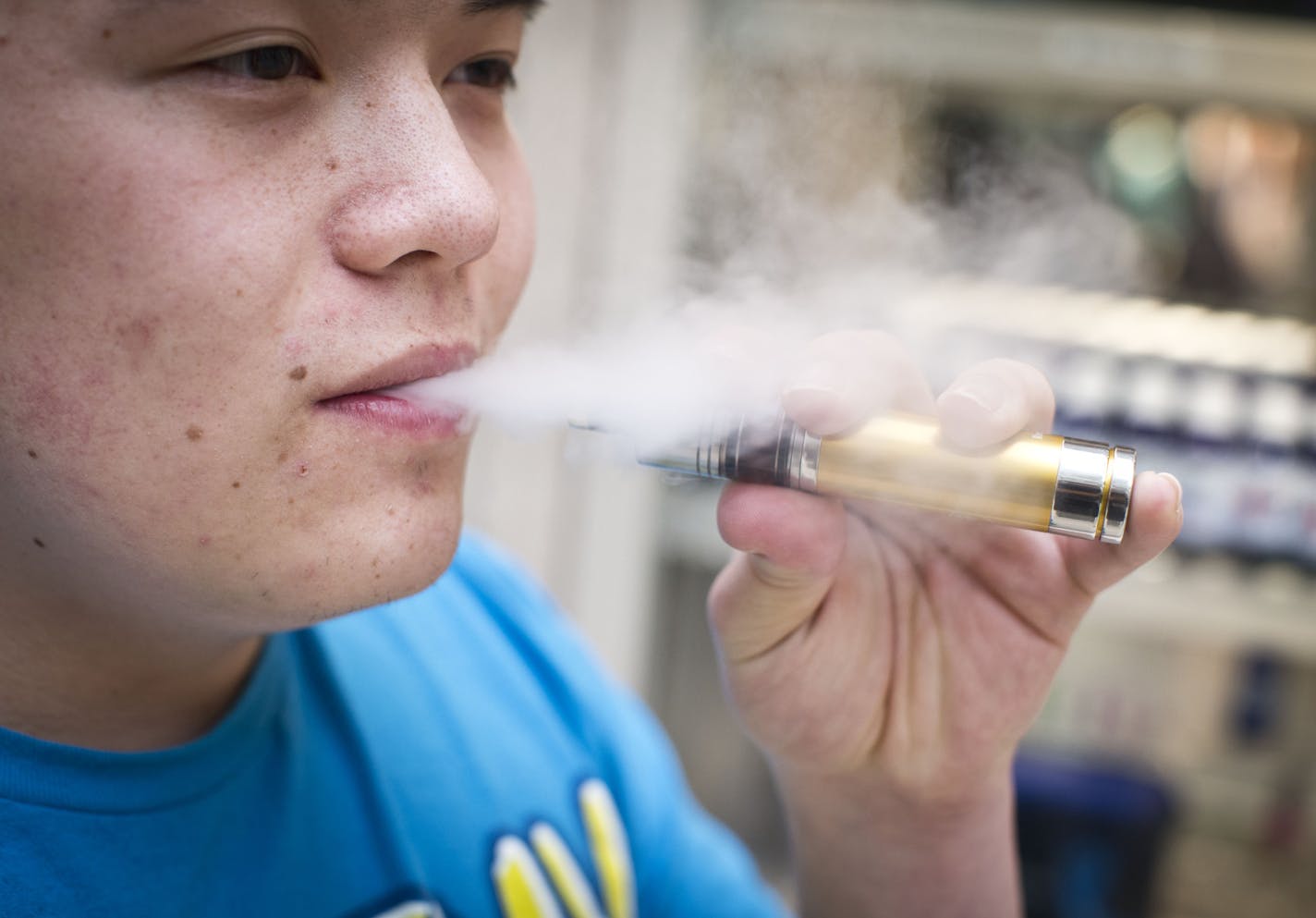 Jesse Ly smoked his e-cigarette at the Smokeless Smoking kiosk at the Roseville Mall in Roseville on Tuesday, March 18, 2014.