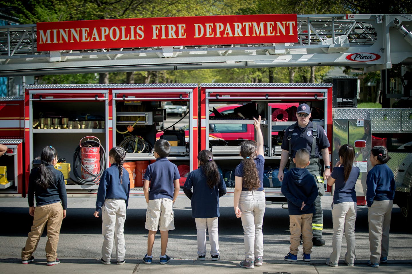 Minneapolis firefighter Mike Jorgensen taught children at the Nellie Stone Johnson school about their jobs and the equipment they use during the Hartford for Fire Safety Day at the school, Tuesday, May 15, 2018 in Minneapolis, MN. More the 200 students at the school were deputized as junior fire marshals. The kids were able to get into a mock house that simulated fire and smoke dangers, met local firefighters, and toured their truck and gear. ] ELIZABETH FLORES • liz.flores@startribune.com