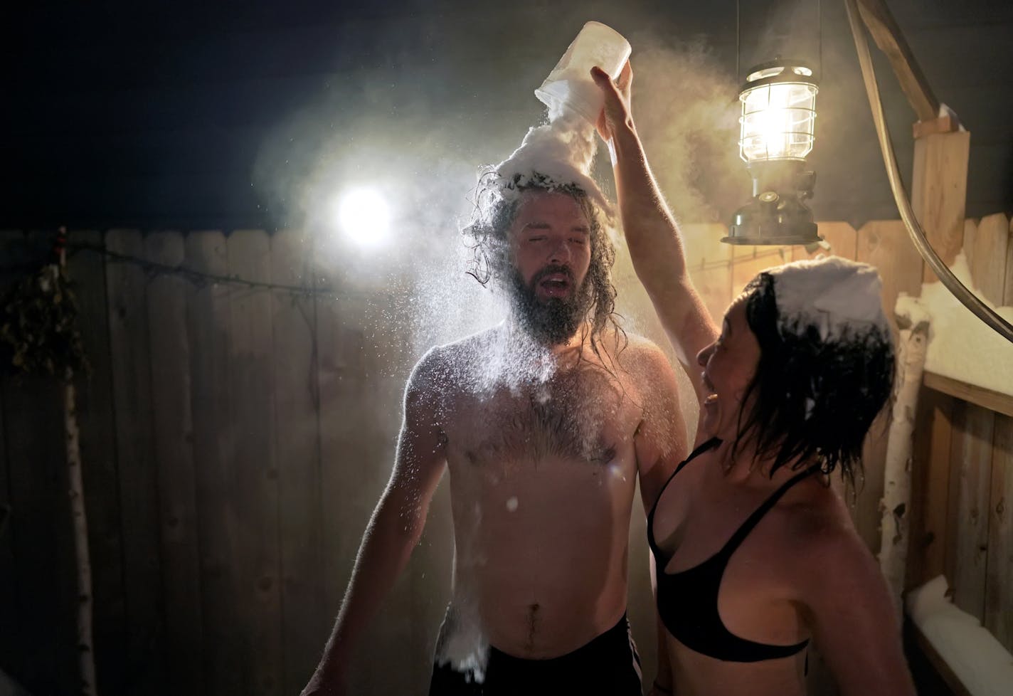 As temperatures dipped into the minus 20 degree range with a -42 windchill, Glenn and Julia Auerbach invited their friends Dan Wilson and Omina Shibahara over to their south Minneapolis home for a backyard sauna. Here, Shibahara gives Wilson a cool down cup of snow over the head. The hot room was 200 degrees and the air temp was 220 degrees colder at minus 20.