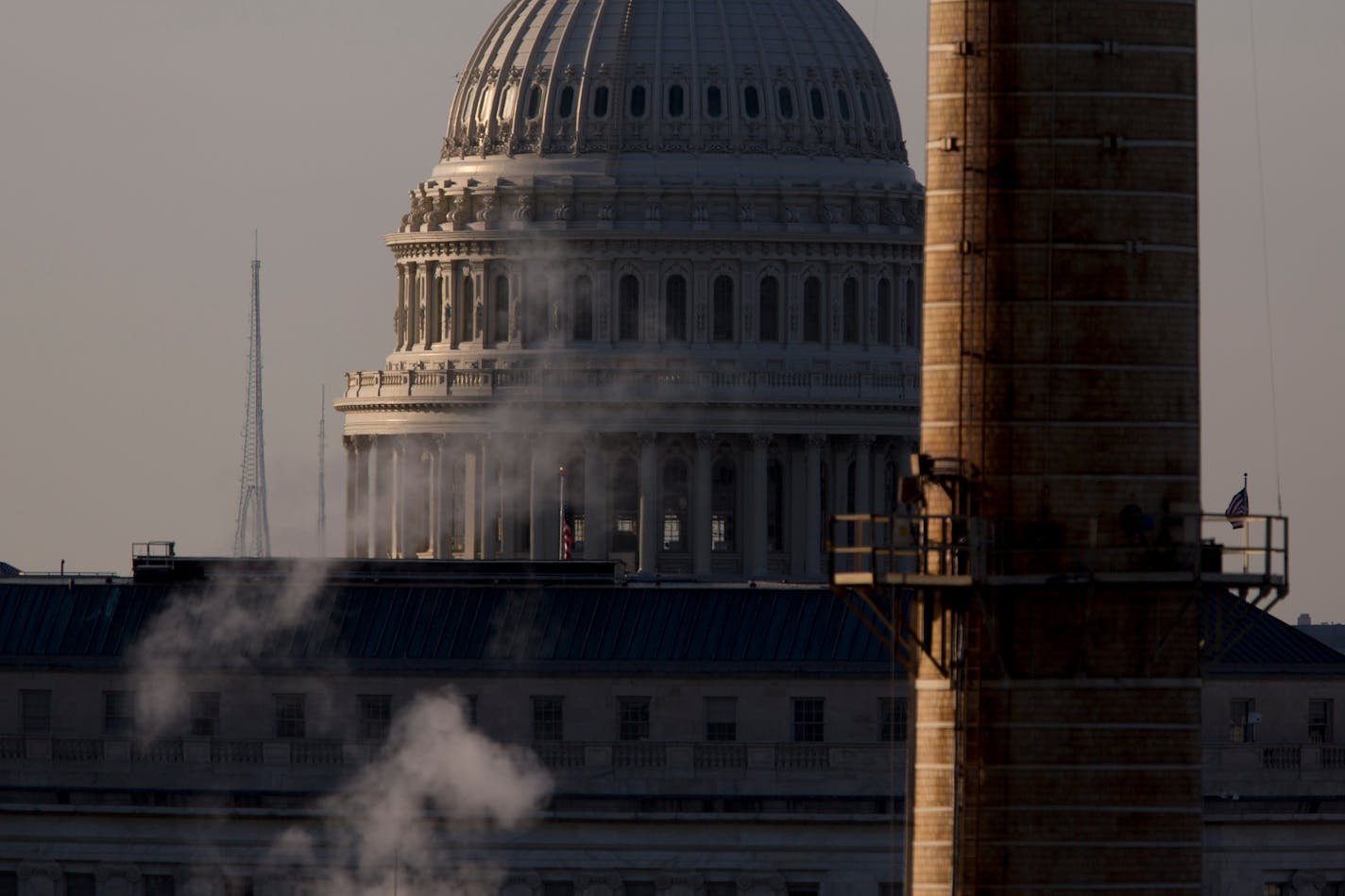 The U.S. Capitol Building stands past the natural gas and coal fueled Capitol Power Plant, which provides heating and cooling throughout the 23 facilities on Capitol Hill including House and Senate Office Buildings, in Washington, D.C., U.S., on Sunday, June 1, 2014. President Barack Obama will propose cutting greenhouse-gas emissions from the nation's power plants by an average of 30 percent from 2005 levels, a key part of his plan to fight climate change that also carries political risks. Phot