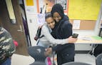 Kadra Mohamed, right, received a hug from a Humboldt High School student after she met with her and another group of teenage girls that she mentored t