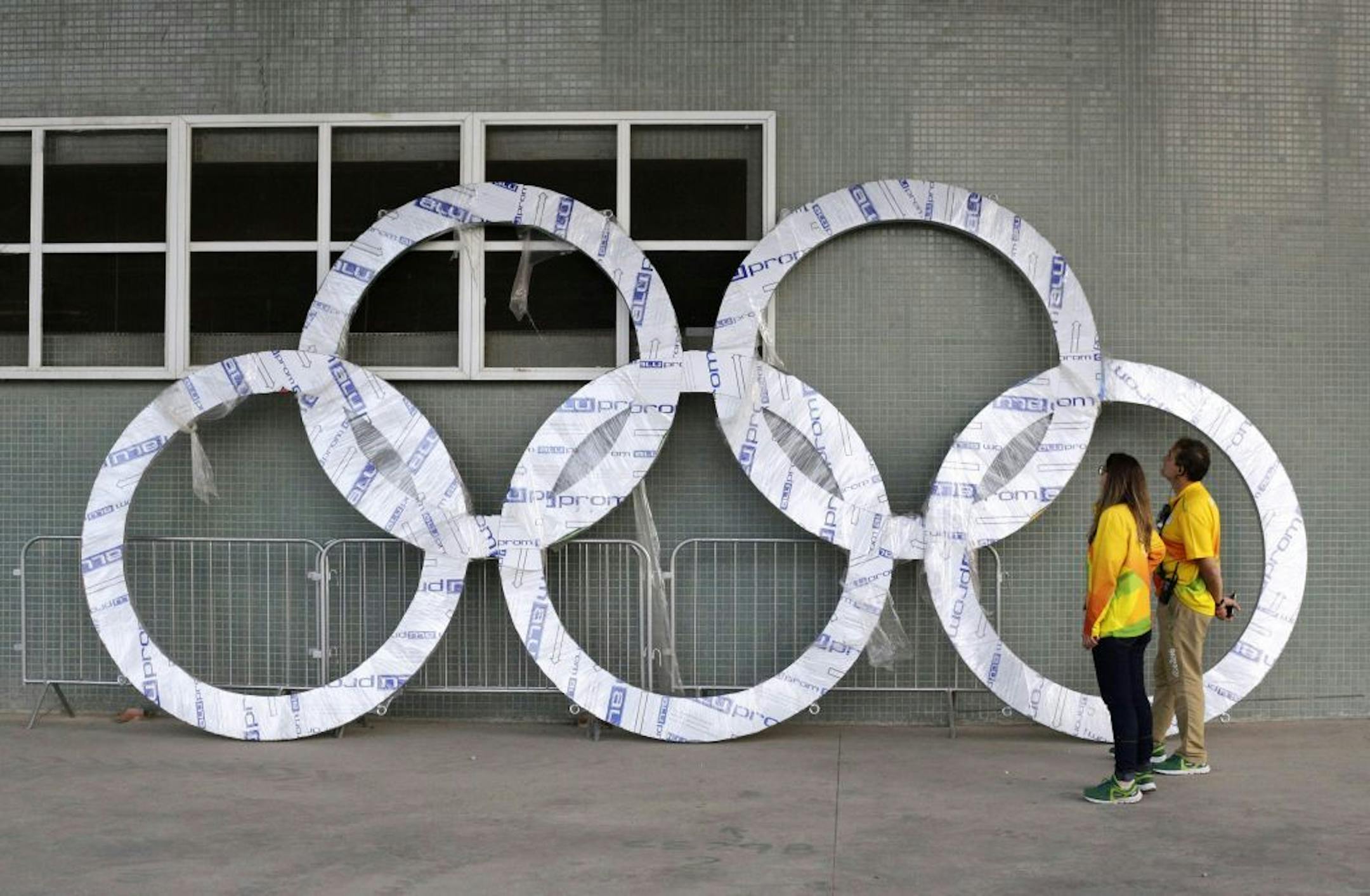 Workers inspect a set of Olympic Rings that are scheduled to be installed inside Olympic Park in Rio de Janeiro, Brazil, Saturday, July 30, 2016. The 2016 Rio de Janeiro Games are scheduled to open Aug. 5.