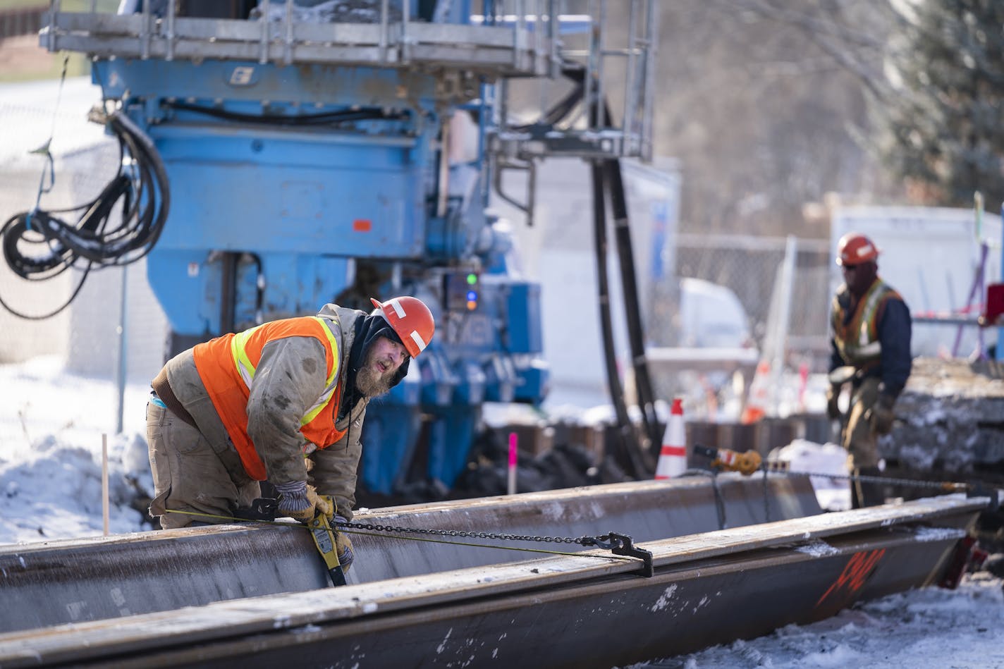 A construction worker from Lunda/McCrossan joint venture prepared a steel pile for the silent piler machine. The steel piles are used to construct the framework for a tunnel for the Southwest Light Rail through the Kenilworth area of Minneapolis.