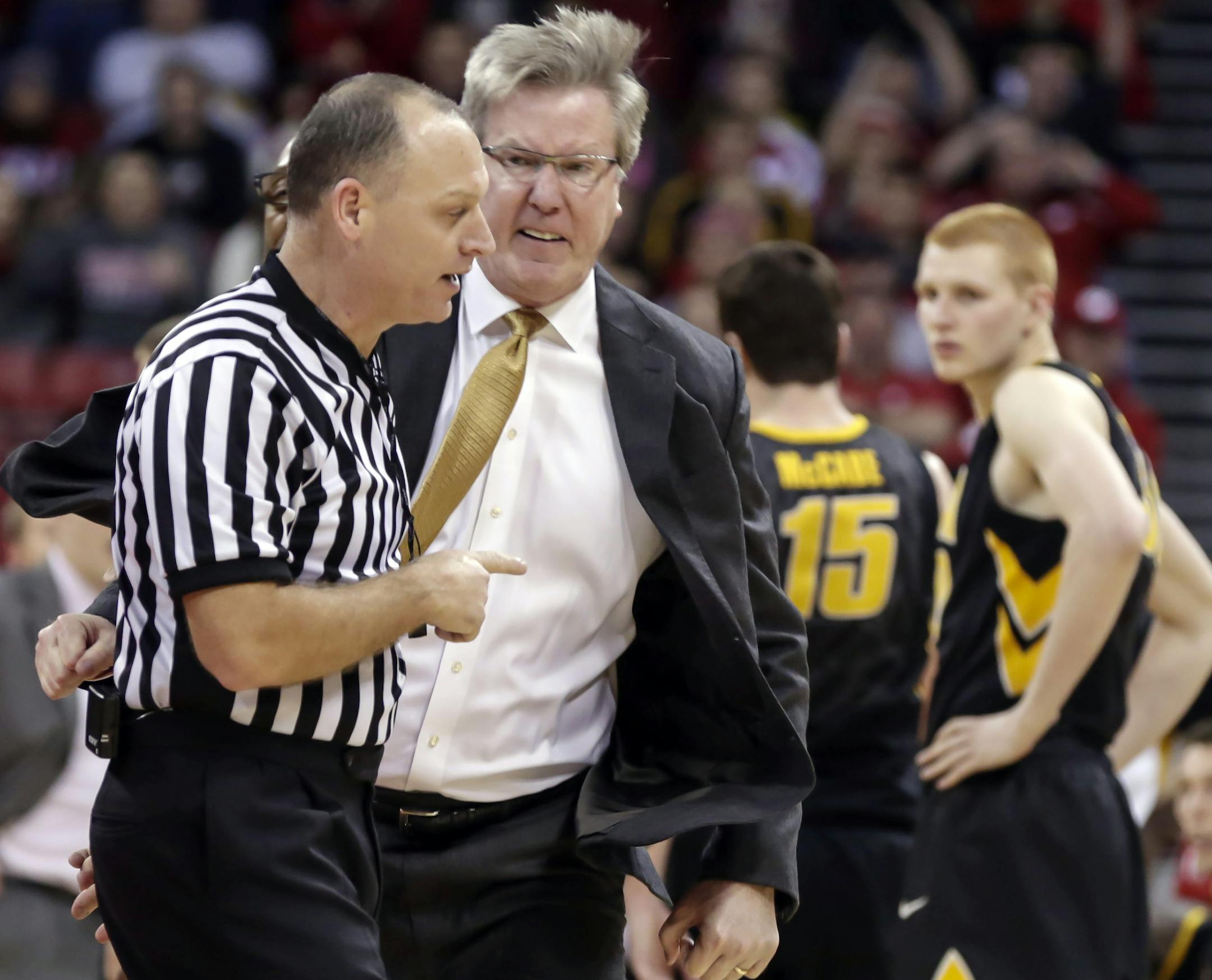 Iowa coach Fran McCaffery, second from left, argues a call during the second half of an NCAA college basketball game against Wisconsin, Sunday, Jan. 5, 2014, in Madison, Wis. McCaffery was ejected from the game and Iowa was charged with two technical fouls. Wisconsin won 75-71. (AP Photo/Andy Manis) ORG XMIT: WIAM108