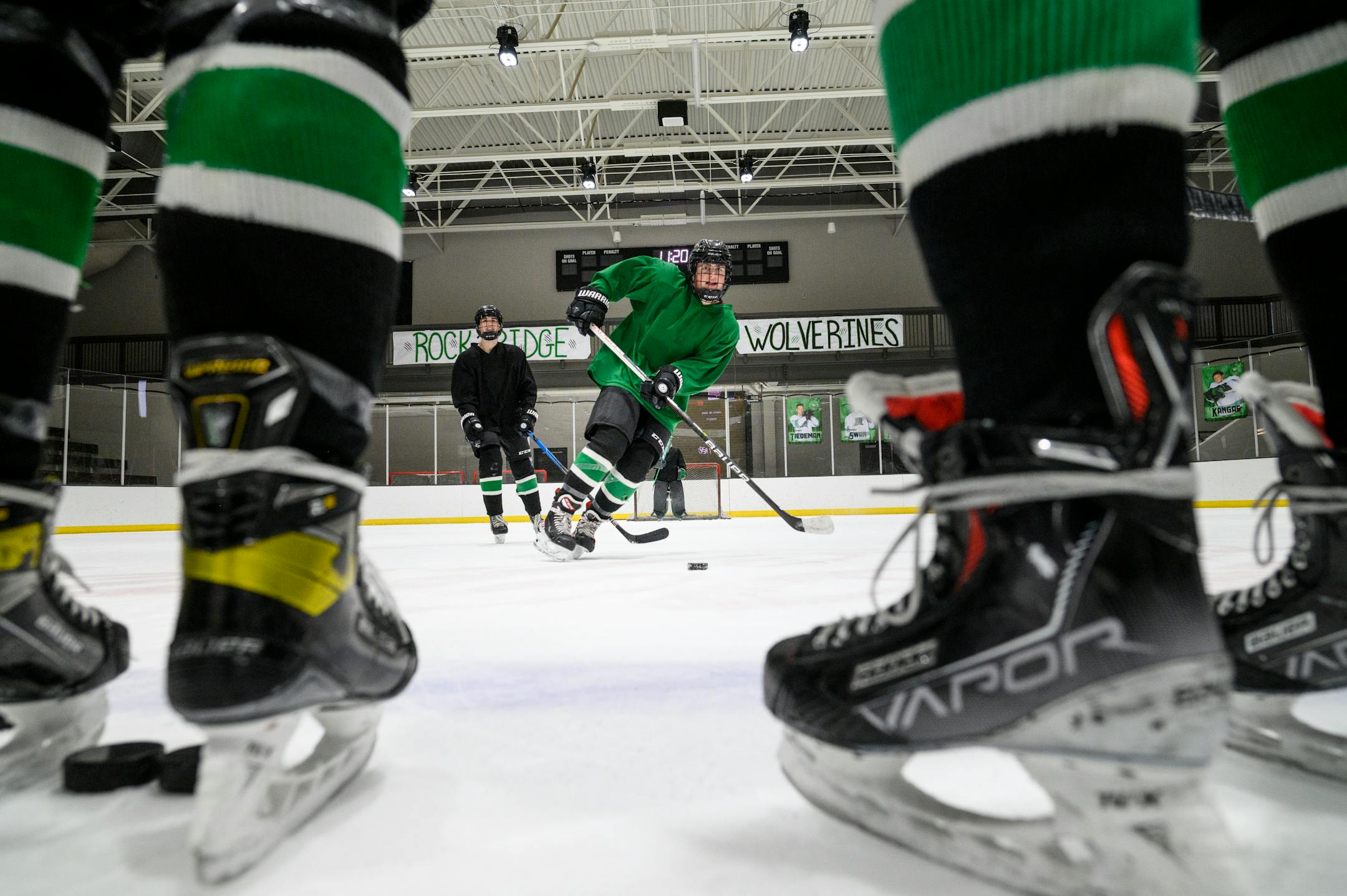 Rock Ridge's Grant Gerlach, center, of Virginia, passes away the puck during practice Tuesday, Feb. 22, 2022 at the Iron Trail Motors Event Center in Virginia, Minn.