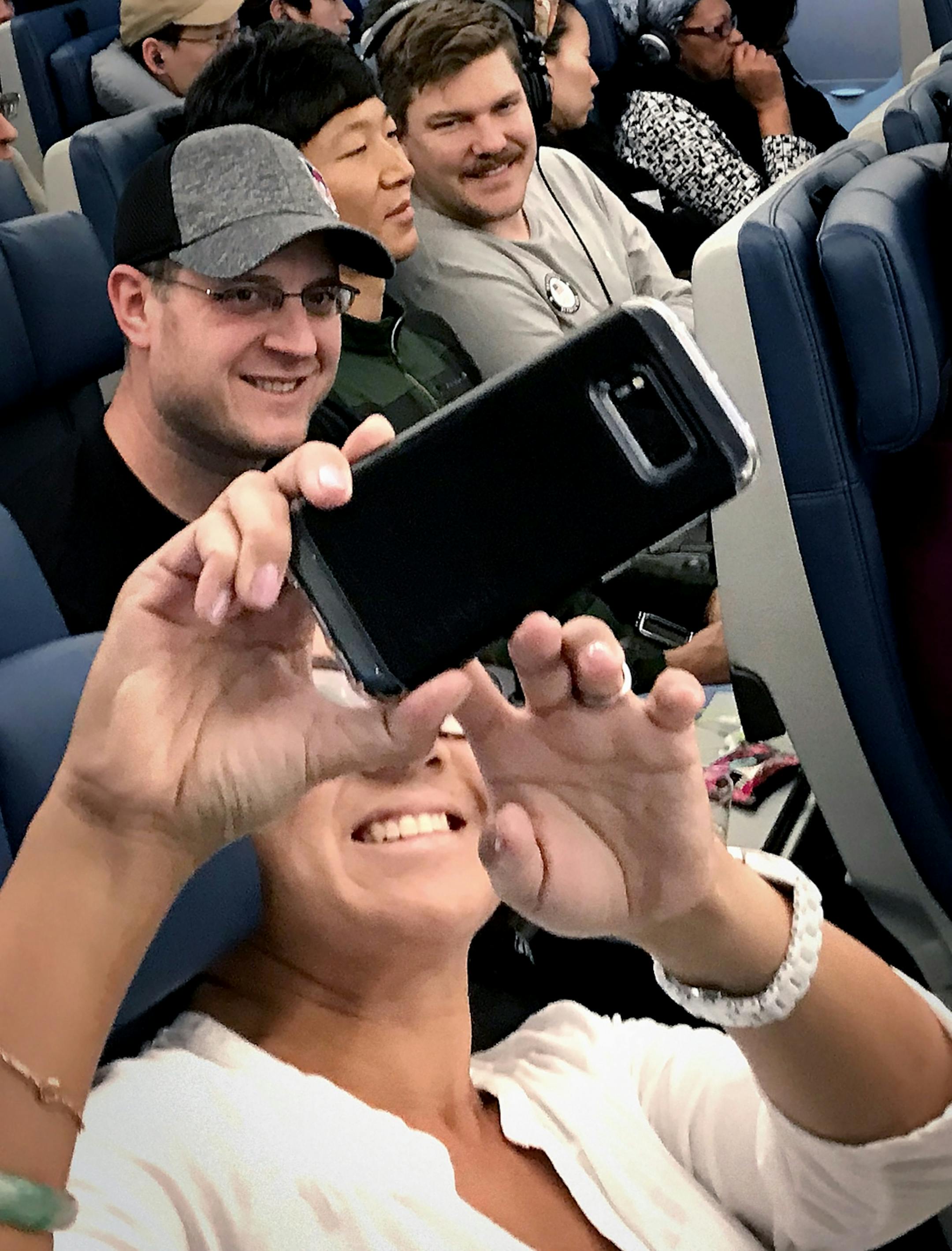 A passenger took a selfie with John Shuster and Matt Hamilton on the flight home from South Korea.