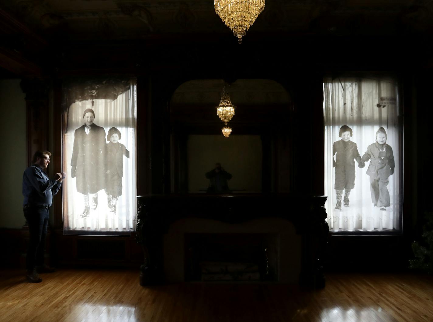 Norway holiday display curator Ethan Bjelland looked at photos of a Norwegian family at Christmastime during World War II.