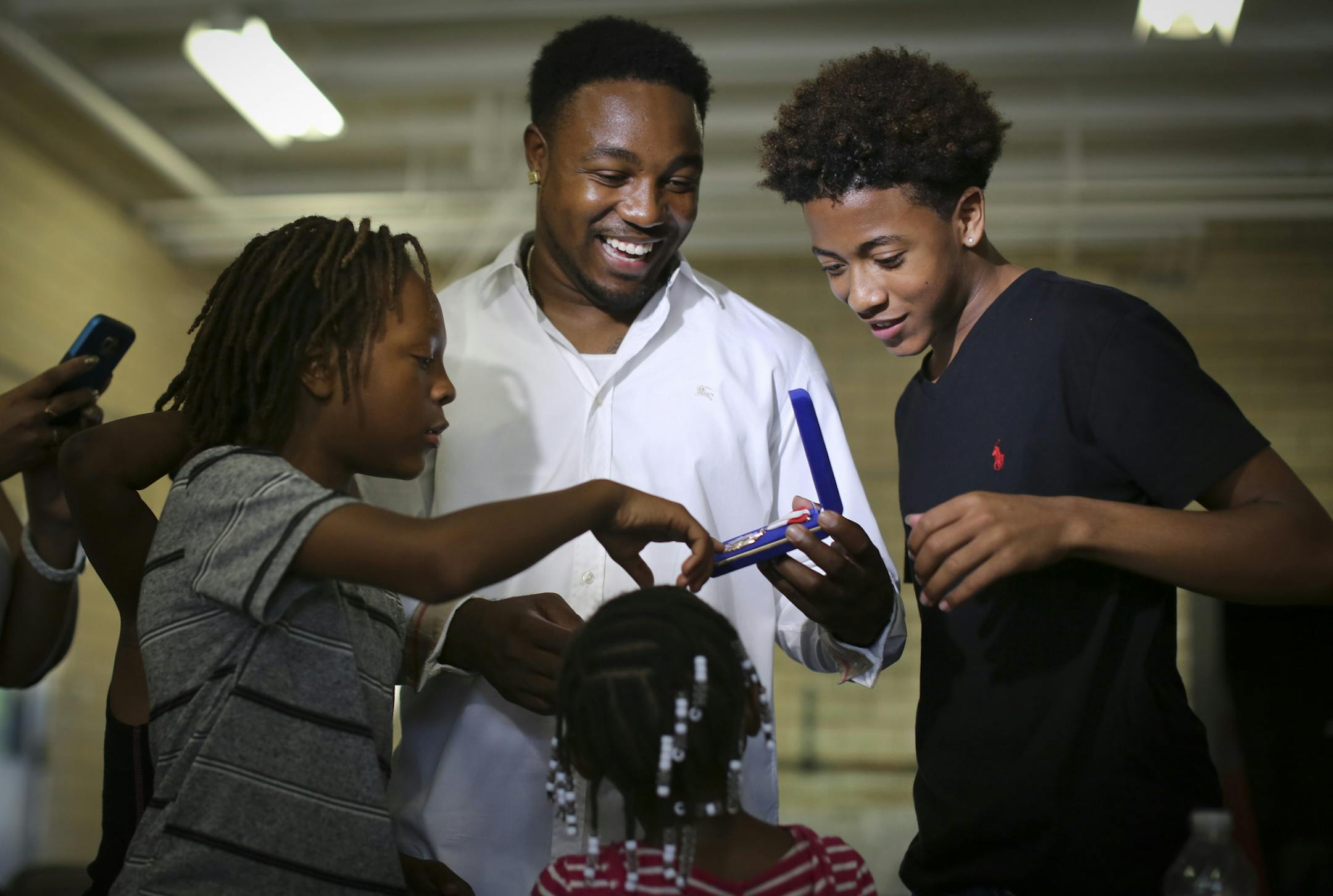 Donnell Gibson on Tuesday with children Donnell Gibson Jr., 11, left, Donnayja Gibson, 7, center, and Kendall Williams, 15.