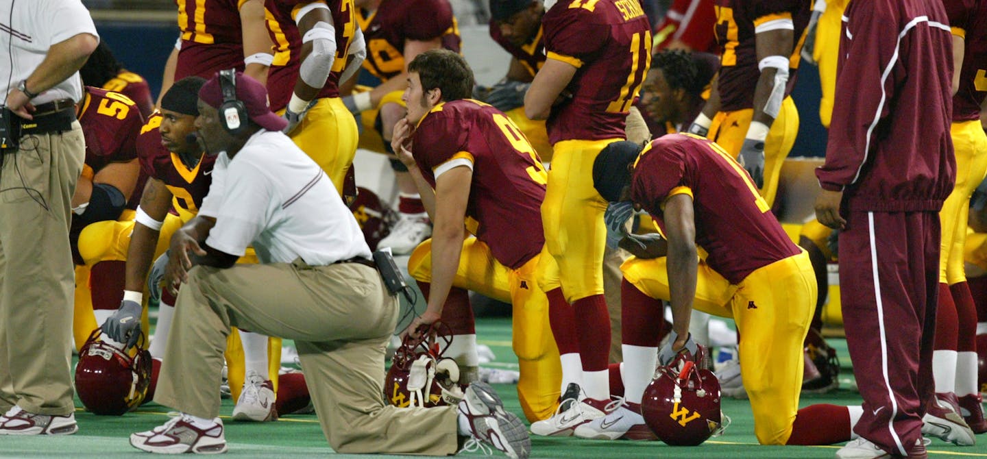 PHOTO- MARLIN LEVISON - The Gopher football team was a bit stunned as the final seconds of the game tick away ensuring Michigan with a come-from-behind victory. ORG XMIT: MIN2013093023293791