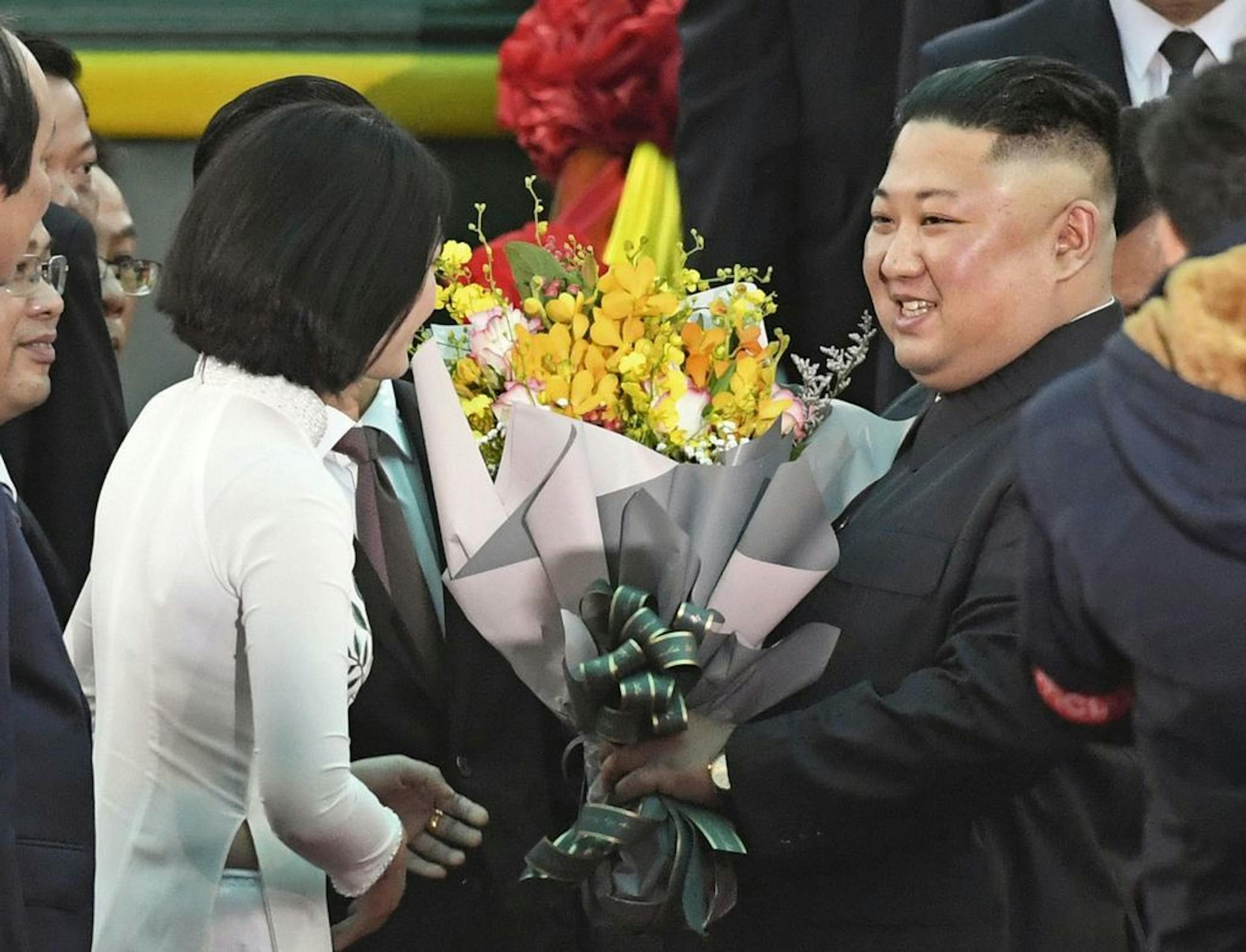 North Korean leader Kim Jong Un, right, receives bouquets on his arrival at the Dong Dang railway station in Dong Dang, a Vietnamese border town Tuesday, Feb. 26, 2019, ahead of his second summit with U.S. President Donald Trump.