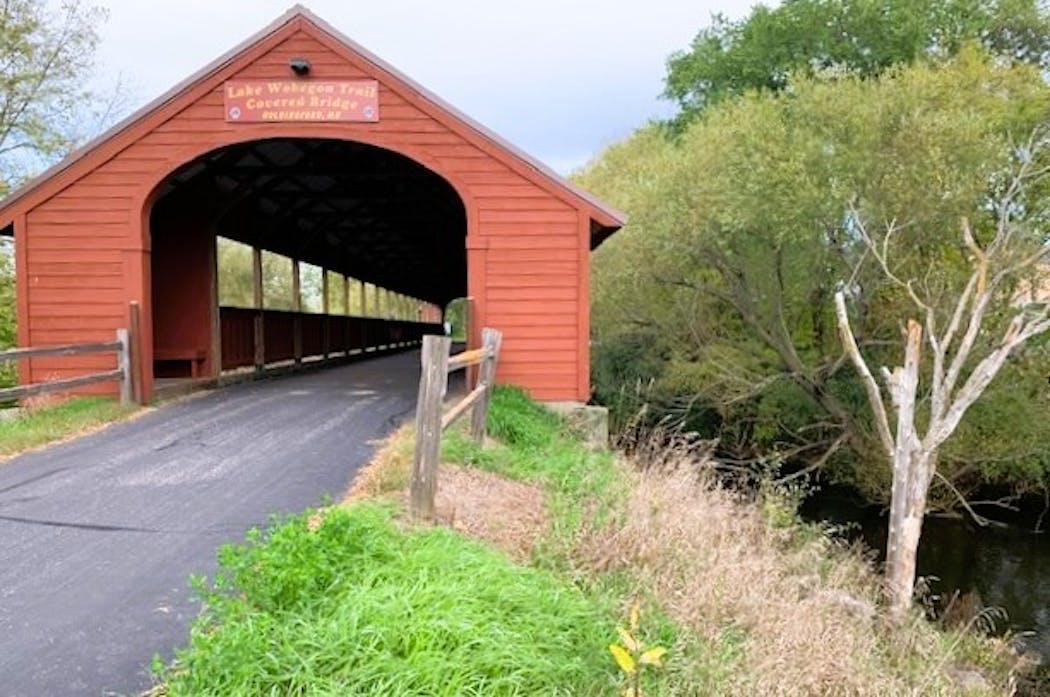 Holdingford, Minn., on the Lake Wobegon Trail, draws cyclists with its Art in Motion cafe and a picturesque red covered bridge.