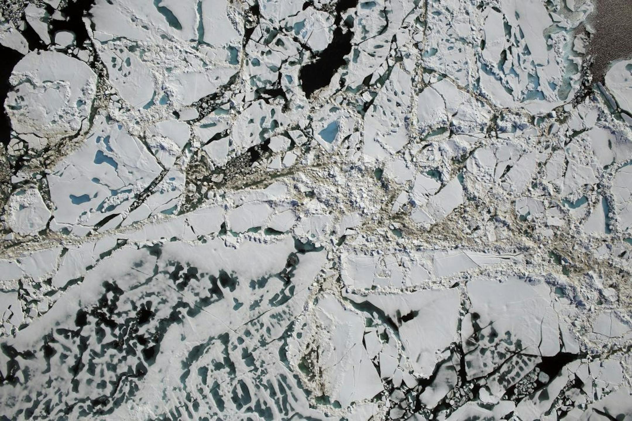 A handout aerial photo from NASA of sea ice, melt ponds and areas of open water in the Chukchi Sea of the Arctic Ocean, July 16, 2016. In mid-November, parts of the Arctic were more than 35 degrees Fahrenheit warmer than observed averages, scientists said. Scientists reported on Jan. 18, 2017, that the Earth reached its highest temperature on record in 2016. It is the first time in the modern era of global warming data that temperatures have blown past the previous record three years in a row. T