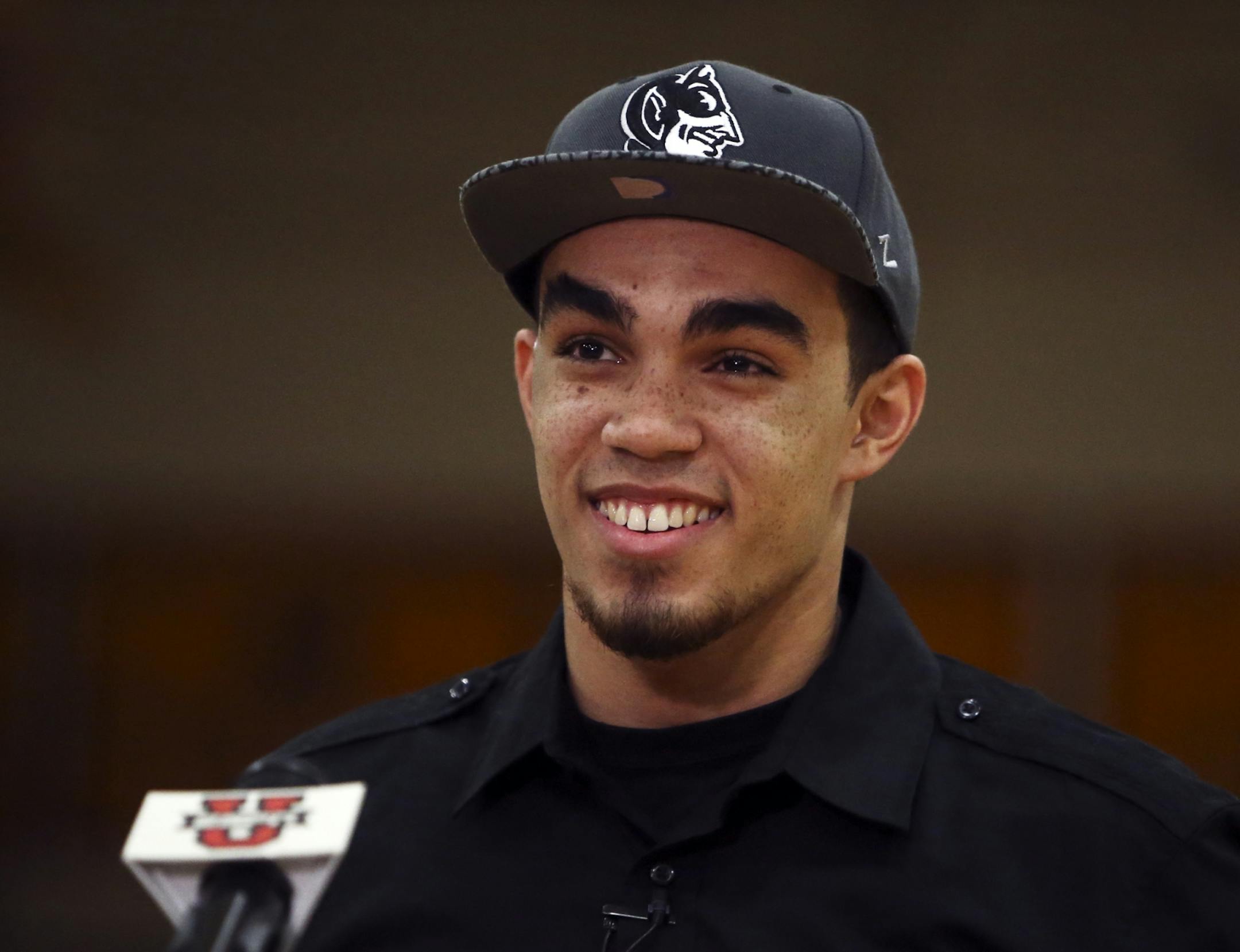 Apple Valley basketball phenom Tyus Jones cracked a few smiles after donning a Duke University Blue Devils hat after announcing he would be attending Duke during a live ESPN televised special Friday, Nov. 15, 2013, at Apple Valley High in Apple Valley, MN.