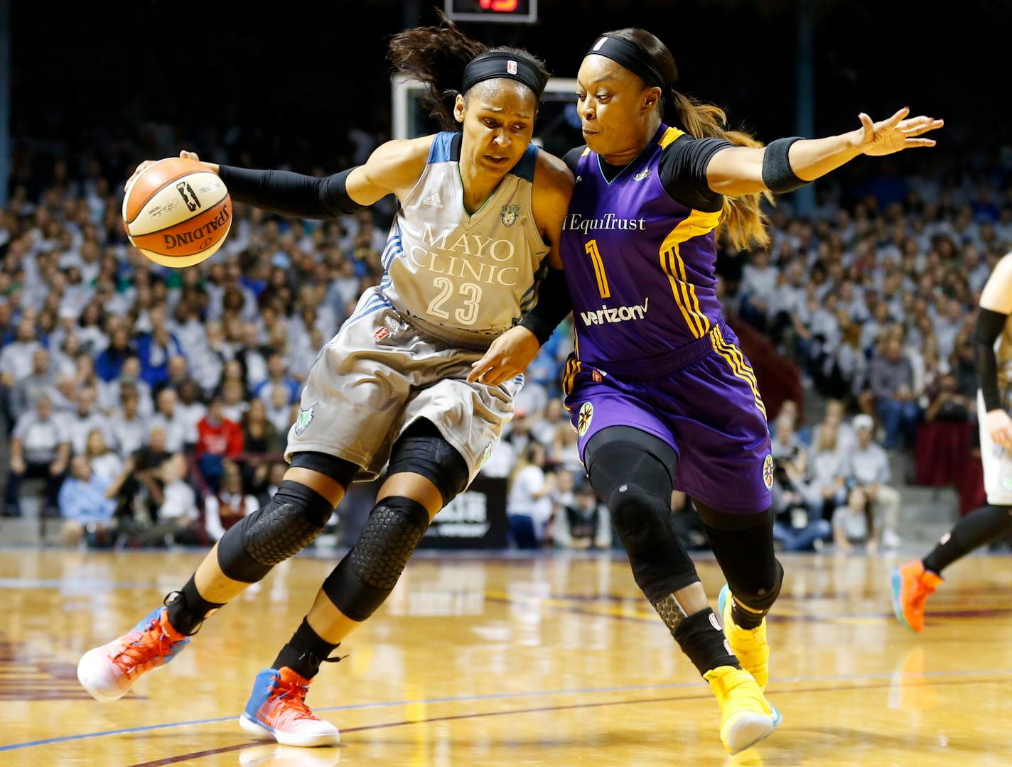 Minnesota Lynx's Maya Moore, left, drives around Los Angeles Sparks' Odyssey Sims during the first half of Game 5 of the WNBA Finals in Minneapolis last fall.