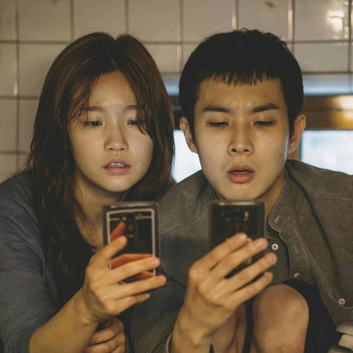 This image released by Neon shows So-dam Park, left, and Woo-sik Choi in a scene from "Parasite." (Neon via AP)