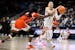UConn guard Paige Bueckers, right, looks to pass while guarded by Syracuse forward Alyssa Latham in the first half of a second-round game in the NCAA 