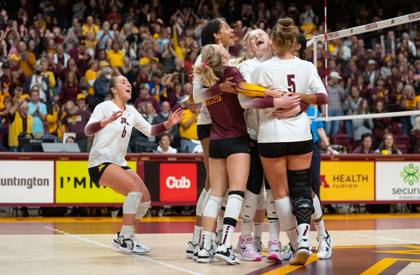 The Minnesota volleyball team celebrates after the game winning point in the fourth set to defeat Purdue 3-1 Saturday, Oct. 22, 2022 at Maturi Pavilion in Minneapolis. ]