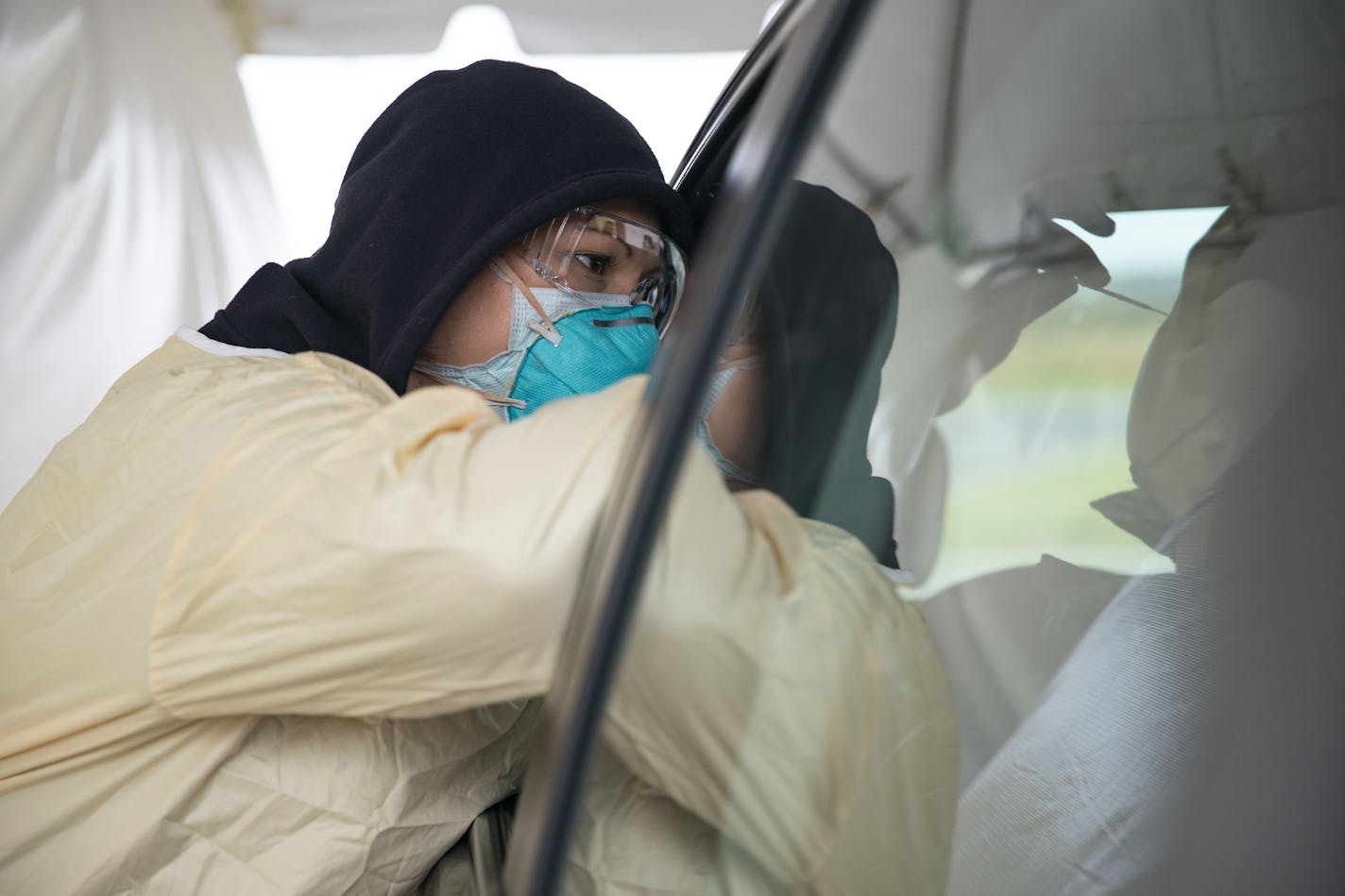 Cheryl Odegaard, a medical assistant at St. Luke's Respiratory Clinic, administered a COVID-19 test to a patient in their drive thru testing site on Thursday. ] ALEX KORMANN • alex.kormann@startribune.com St. Luke's Respiratory Clinic administers an average of 50 COVID-19 tests each day. The testing site saw around that number on Thursday September 24, 2020.