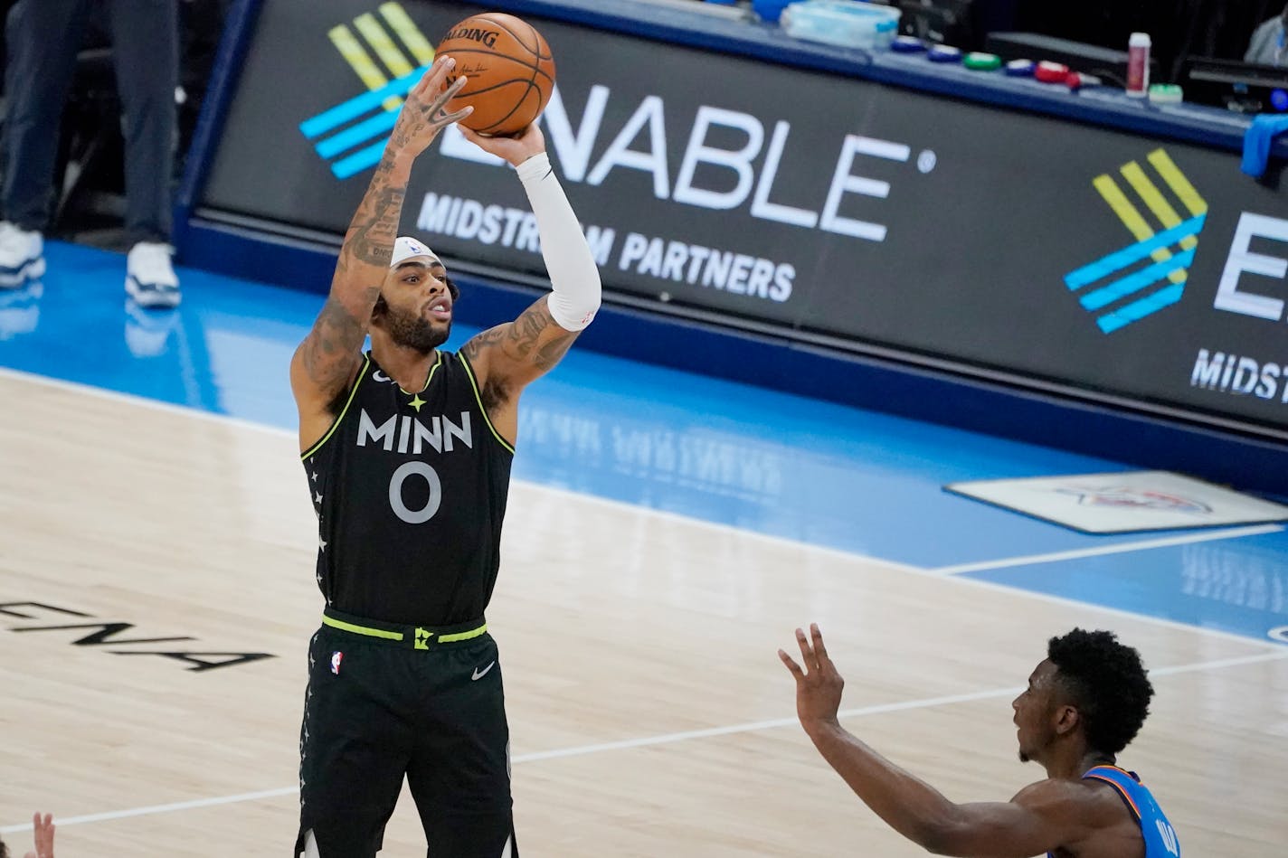 Timberwolves guard D'Angelo Russell shoots a three-point basket over Oklahoma City guard Hamidou Diallo in the final seconds