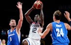 United States's Jrue Holiday (12) drives to the basket between the Czech Republic's Tomas Satoransky (8) and Jan Vesely (24) during a men's basketball