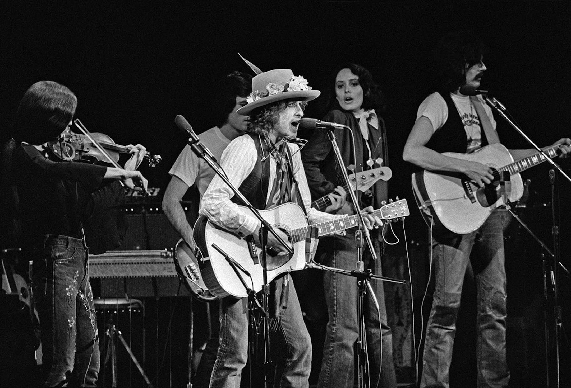 Bob Dylan sings during a benefit performance for Rubin "Hurricane" Carter that also included performances by Roberta Flack, Ronee Blakley, Arlo Guthrie, Joni Mitchell and Roger McGuinn, at Madison Square Garden in New York, Dec. 8, 1975. Carter, a star prizefighter whose career was cut short by a murder conviction in New Jersey and who became an international cause c�l�bre while imprisoned for 19 years before the charges against him were dismissed, died April 20, 2014, at his home in Toronto. He